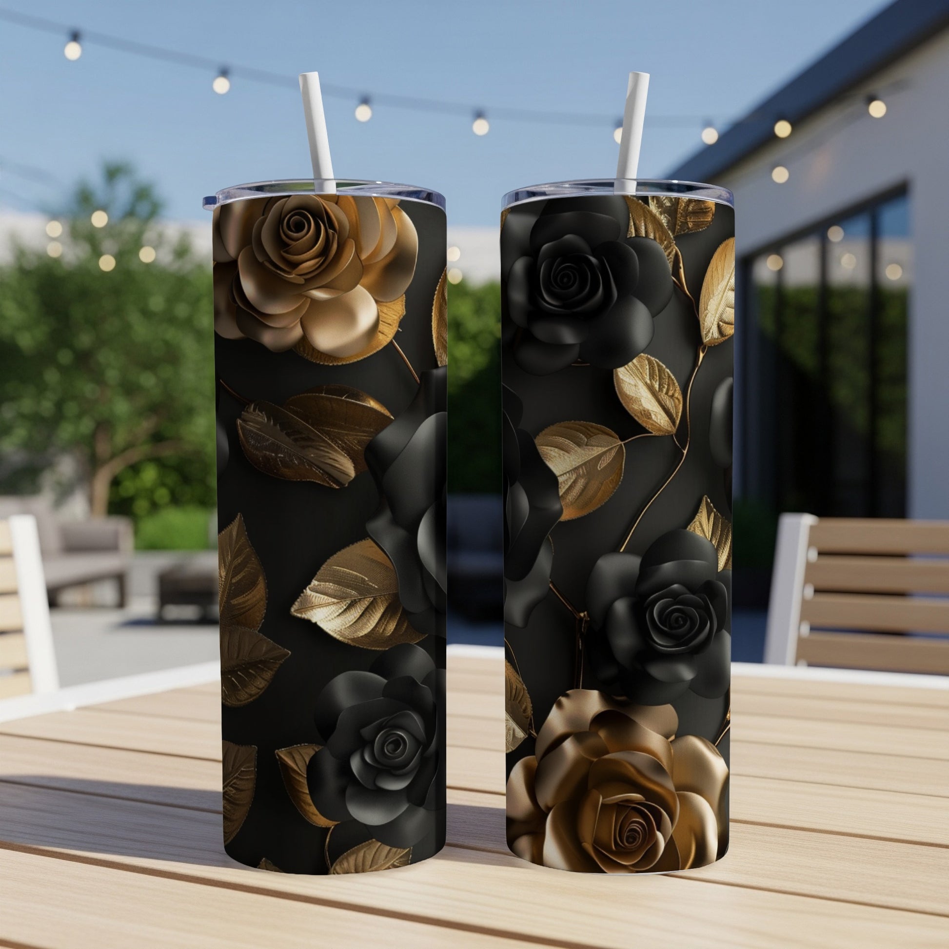Two stainless steel tumblers with black and gold rose floral patterns.