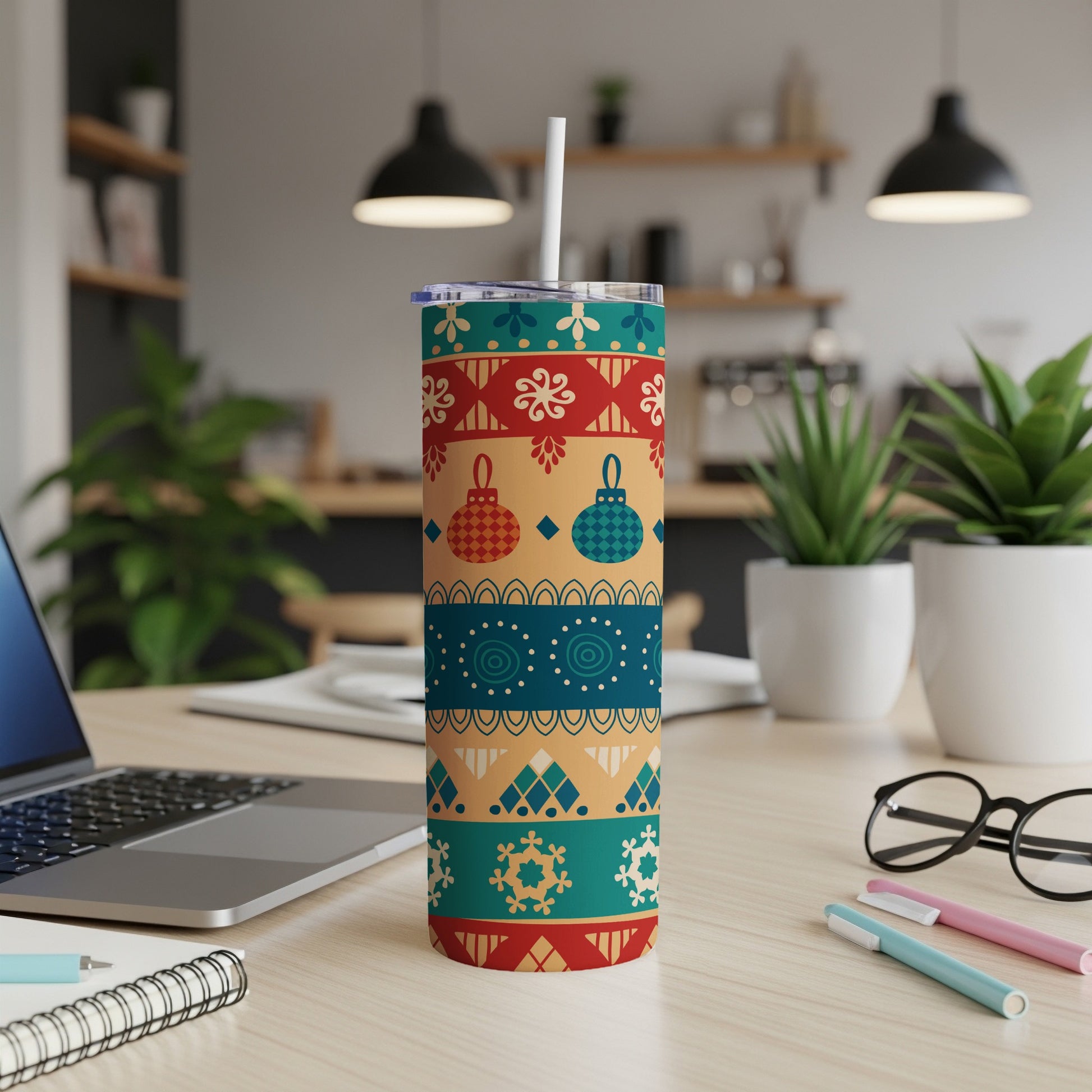 Christmas tumbler with colorful ornaments and snowflake patterns.