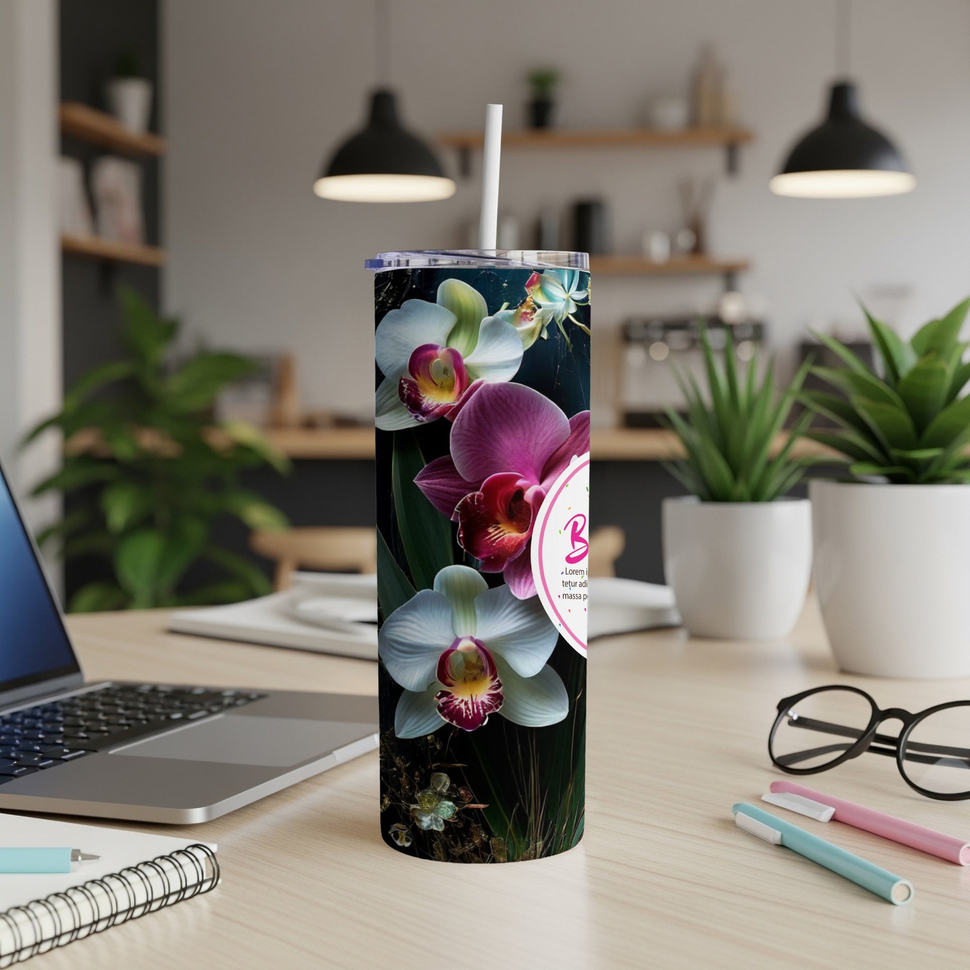Tumbler with pink and white orchids and "Birthday" text on a desk.