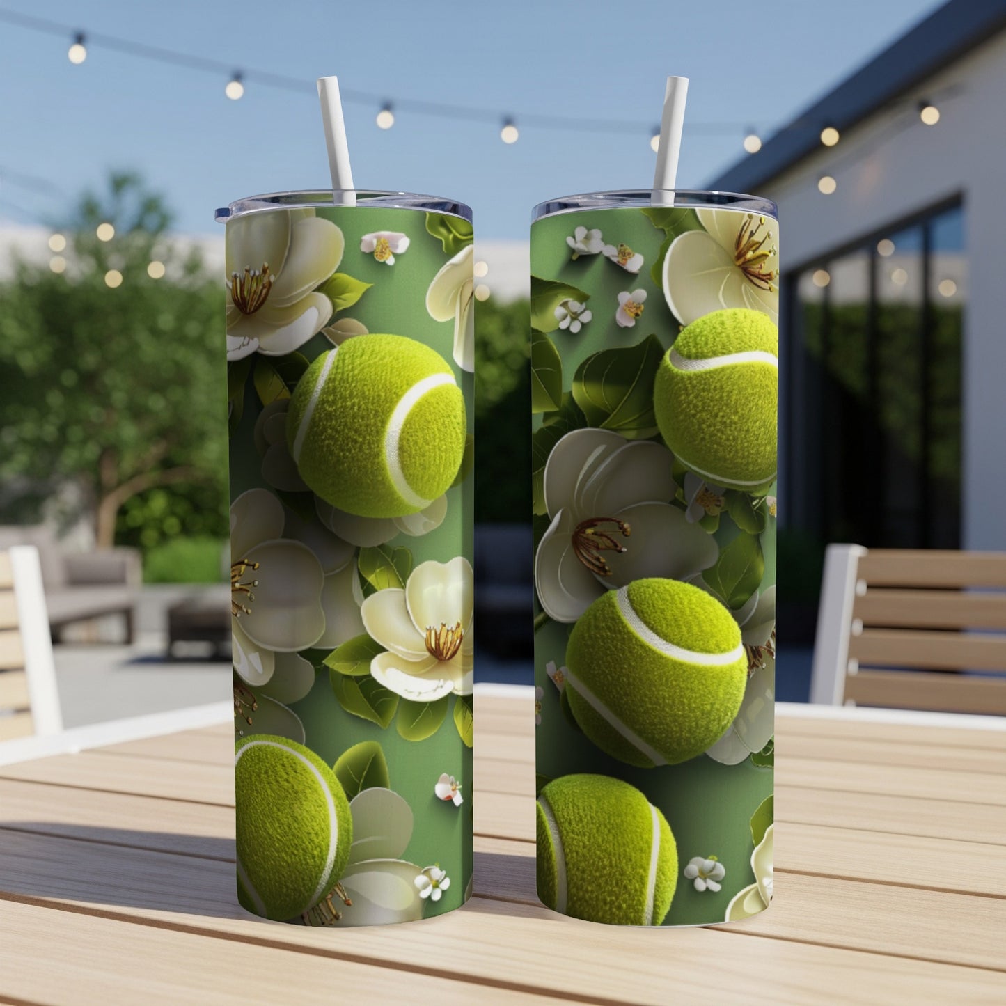 Two green tennis balls with white flowers on a green tumbler.