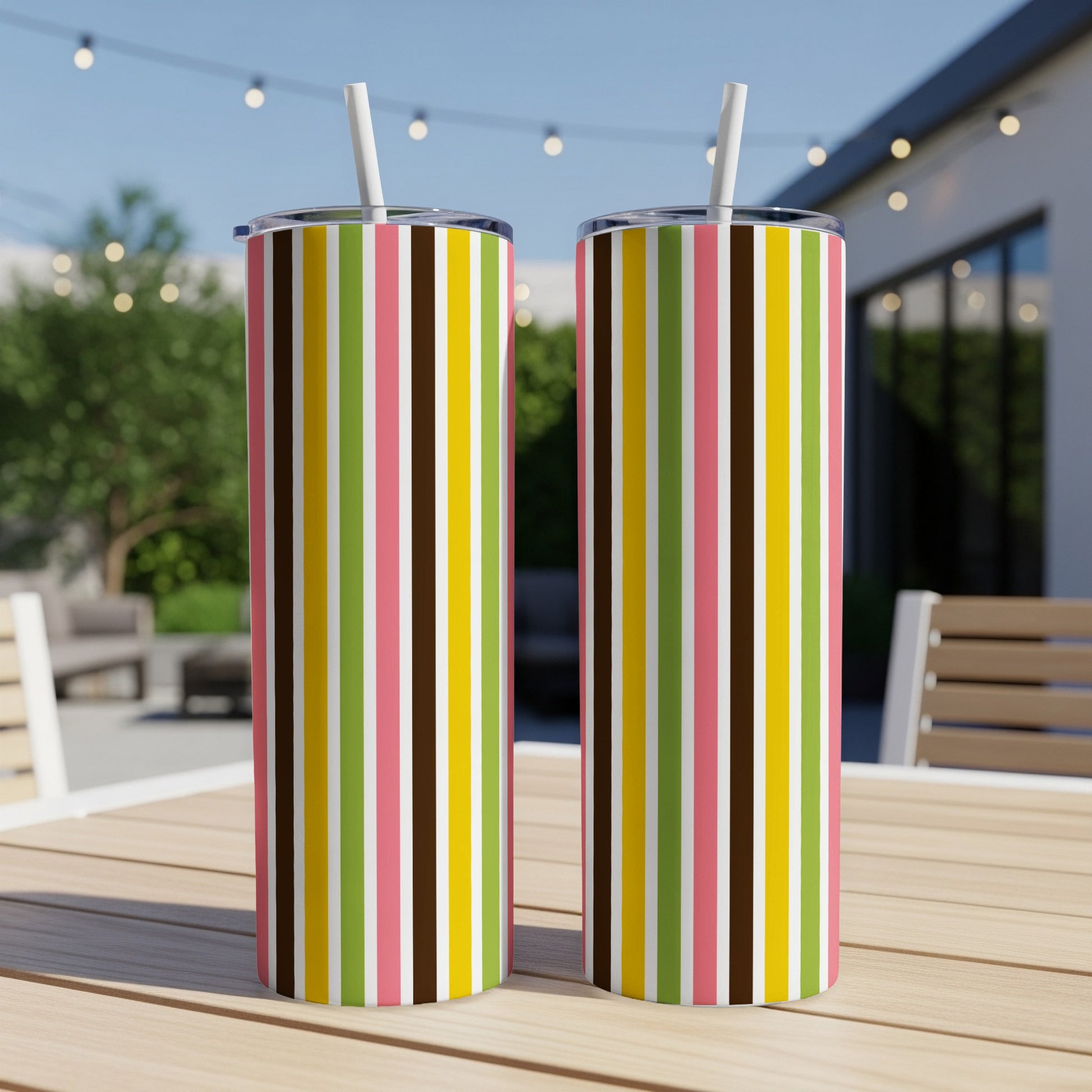 Two tumblers with pink, brown, yellow, green, and white vertical stripes and straws.