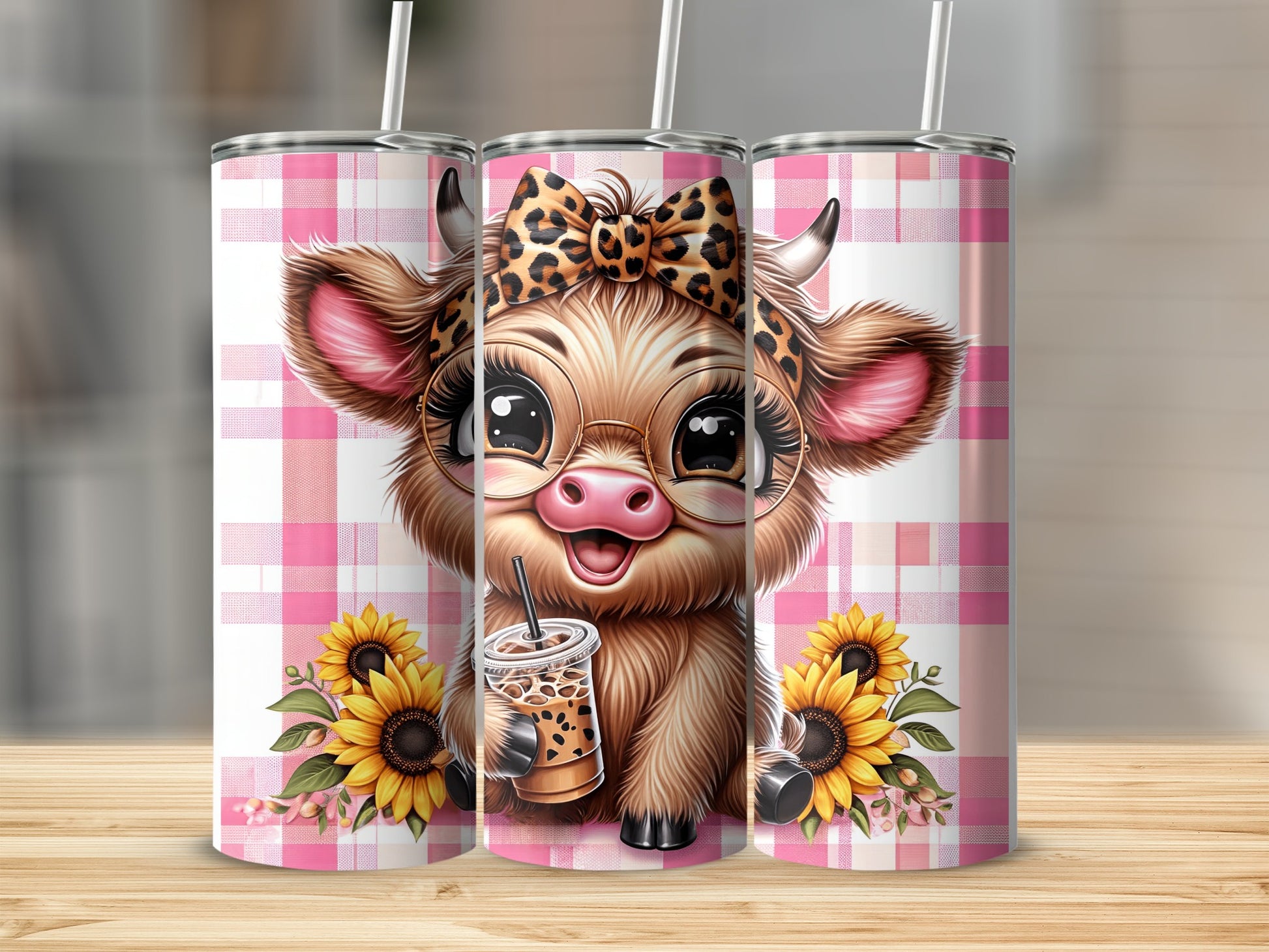 Cute cow with sunflowers and iced coffee on a pink plaid background.