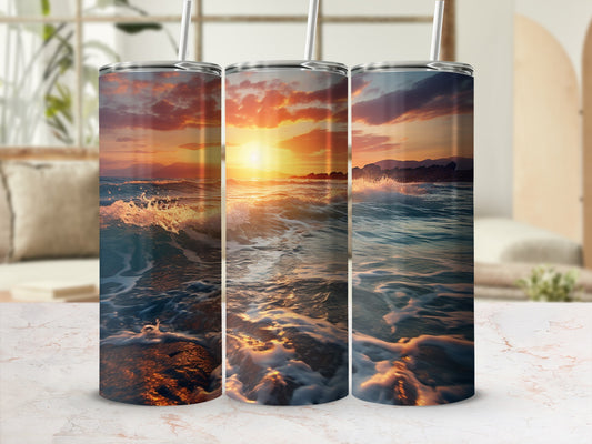 Three tumblers with sunset ocean wave designs, blurred background.