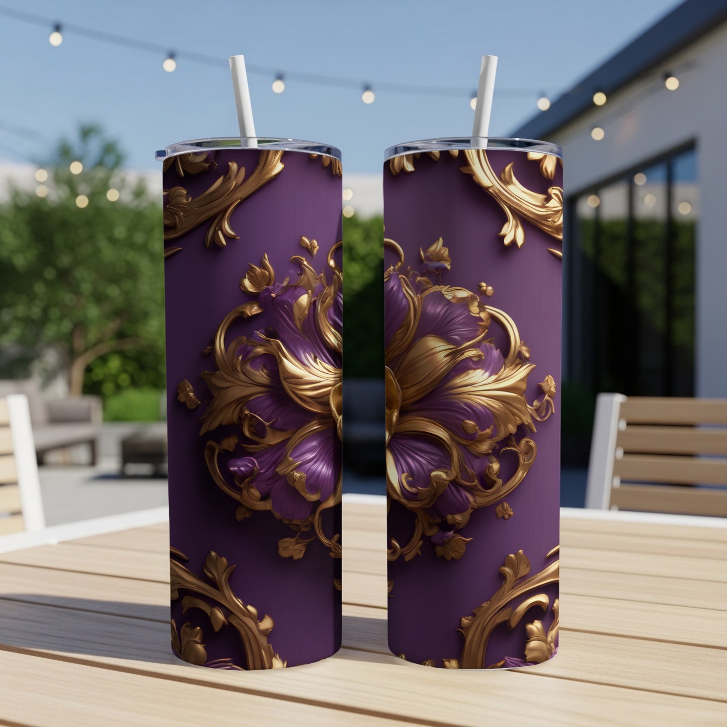 Two purple tumblers with ornate gold floral designs, outdoors on a table.
