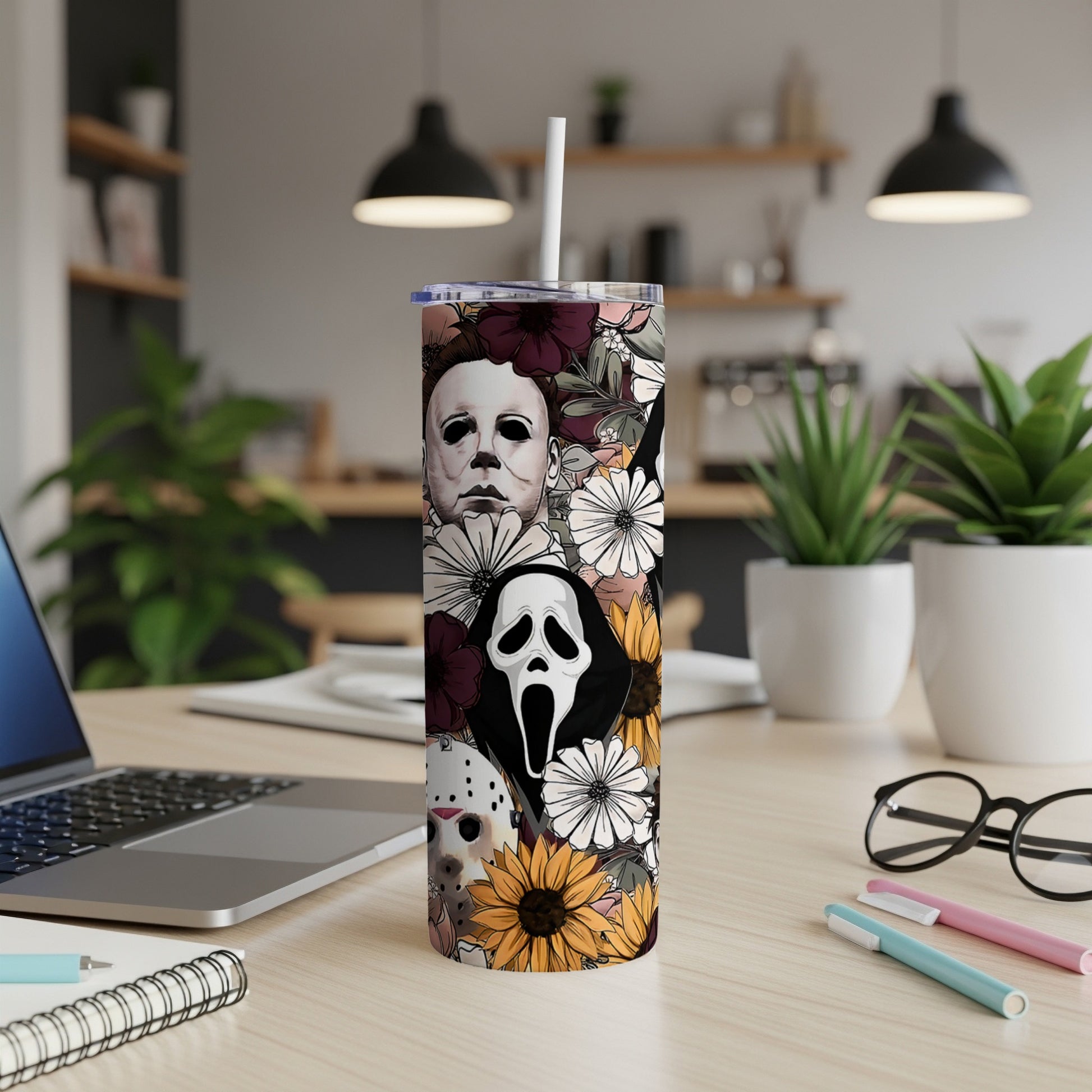 Tumbler with horror movie masks and floral pattern.