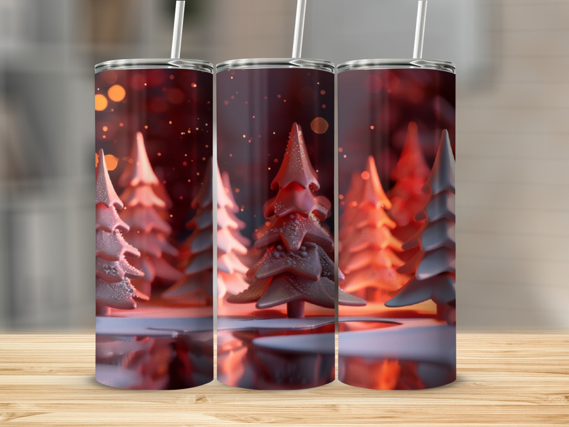 Three decorative tumblers with a festive winter forest design.