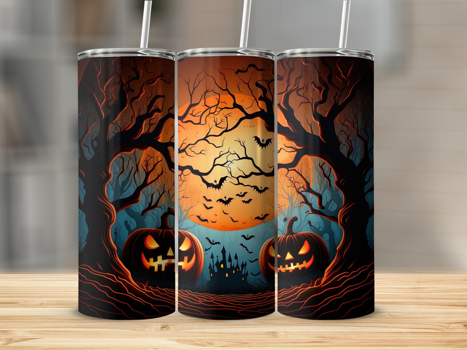 Three tumblers with a Halloween scene of pumpkins, bats, and a castle.