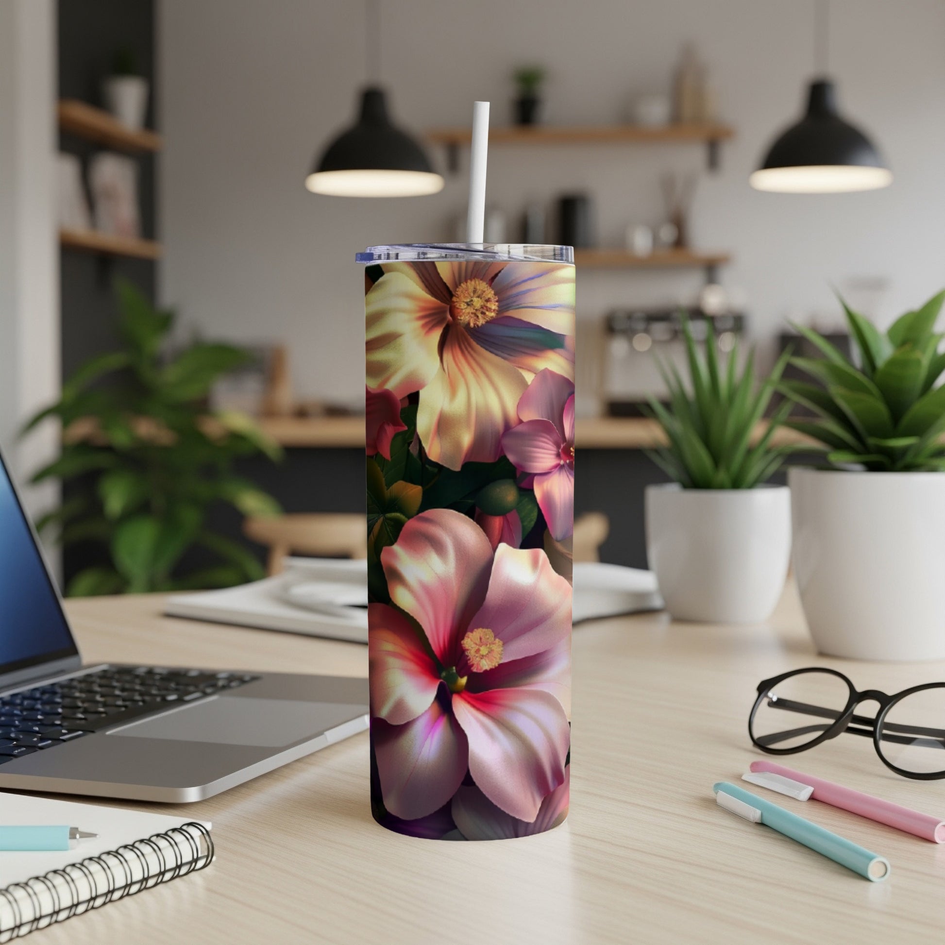 Floral pattern tumbler with a white straw on a wooden desk.