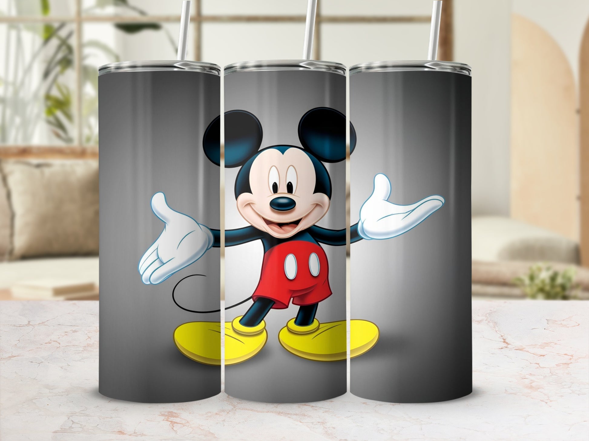 Mickey Mouse on a gray tumbler with a straw.