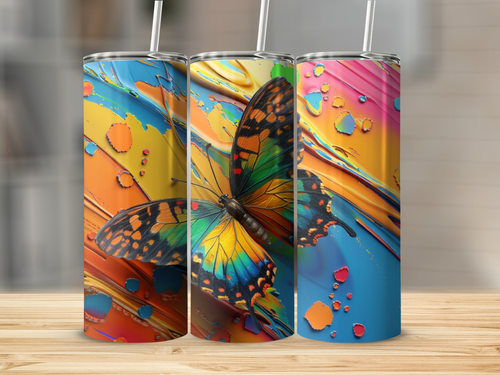 Three tumblers with colorful abstract backgrounds and a butterfly graphic.