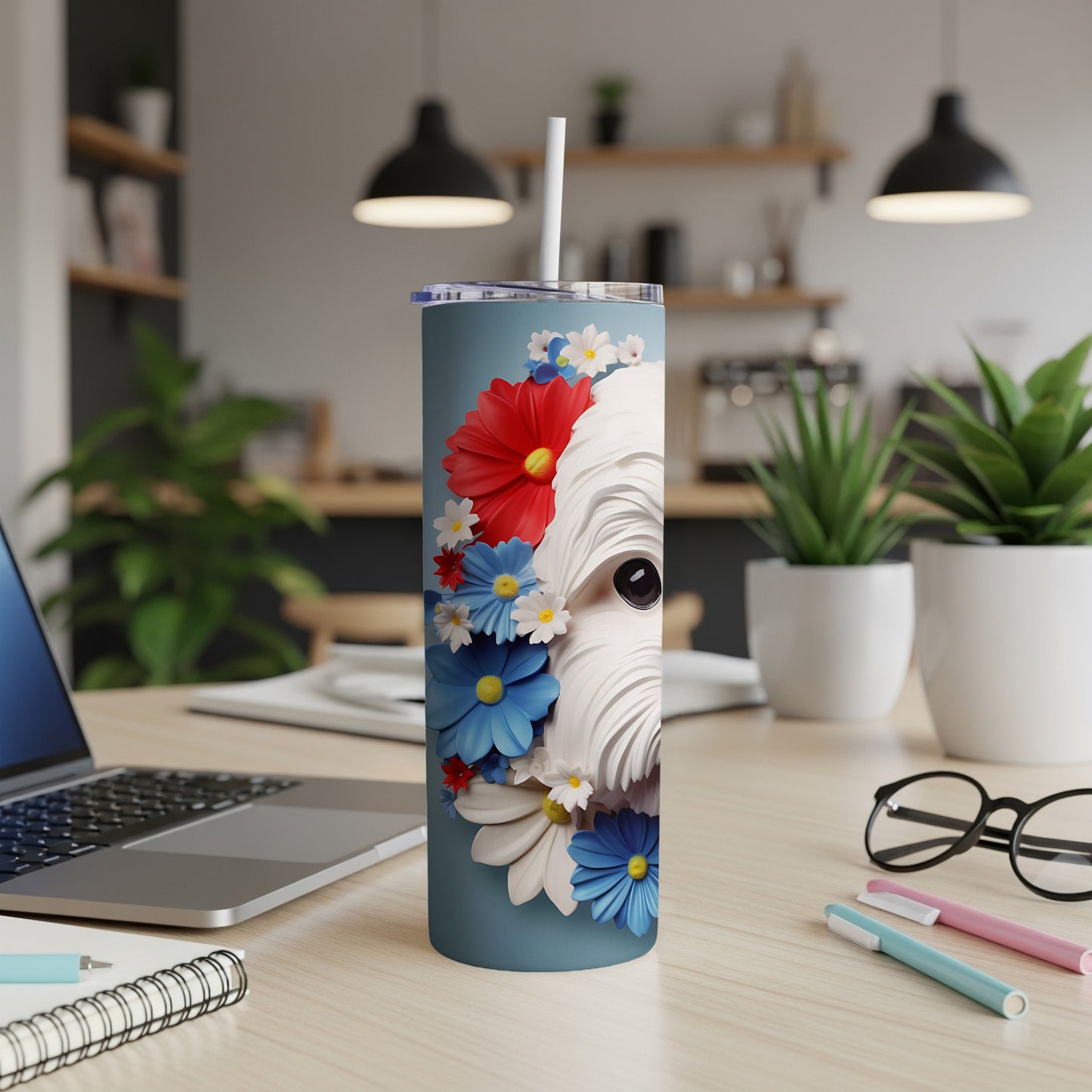 White dog face with red and blue flowers on a skinny tumbler with straw.