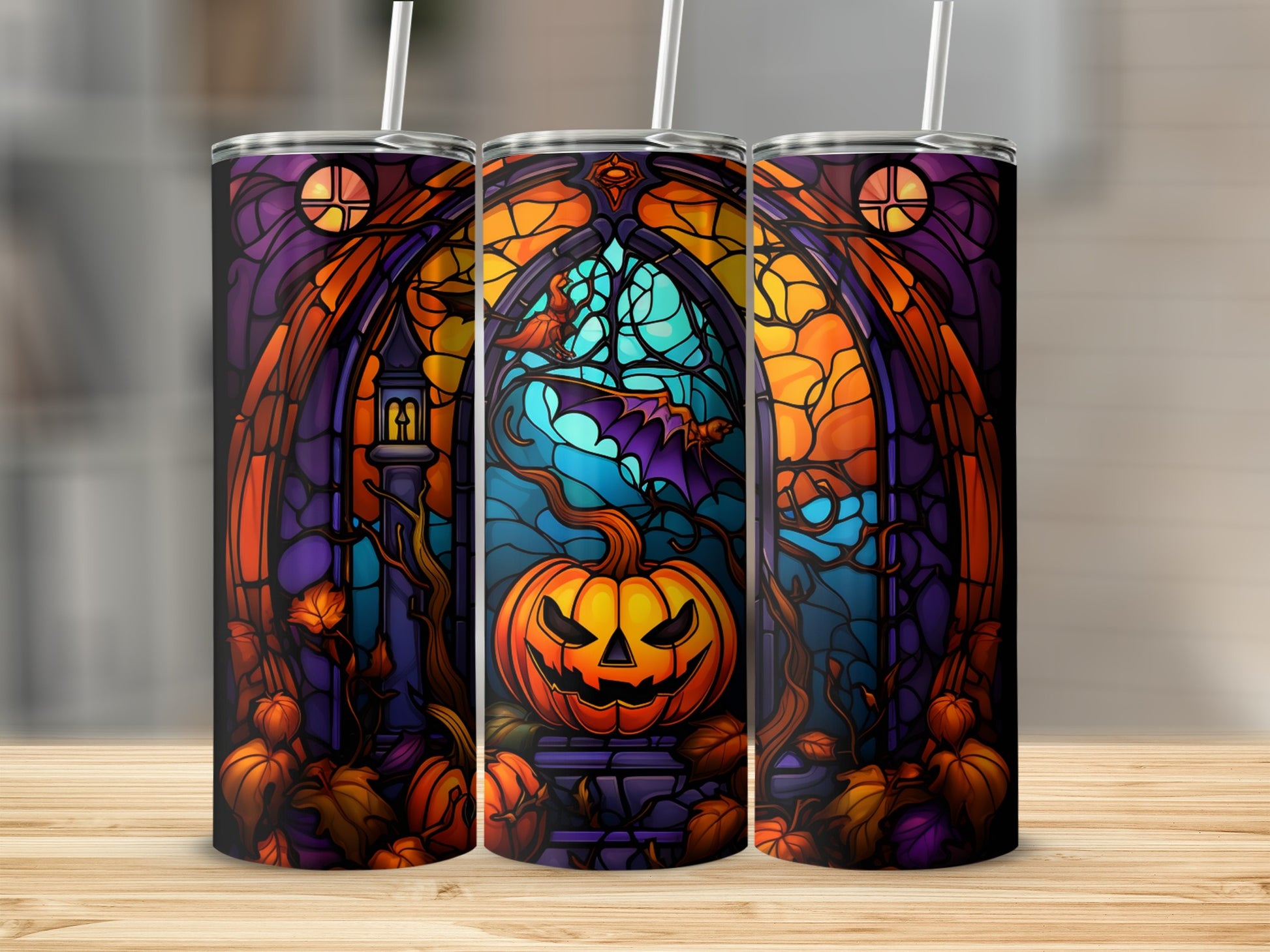 Three Halloween-themed tumblers with jack-o'-lantern, bat, and stained-glass motifs.