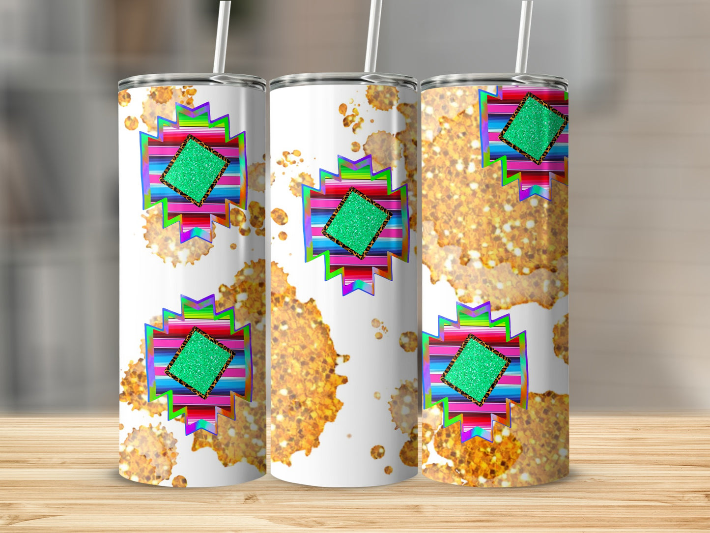 Three tumblers with colorful geometric patterns and gold glitter accents.