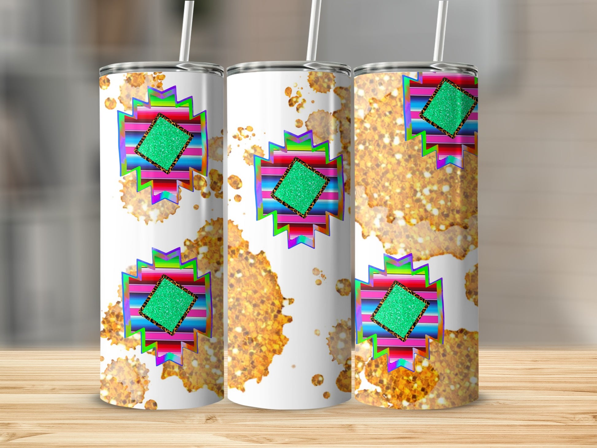 Three tumblers with colorful geometric patterns and gold glitter accents.