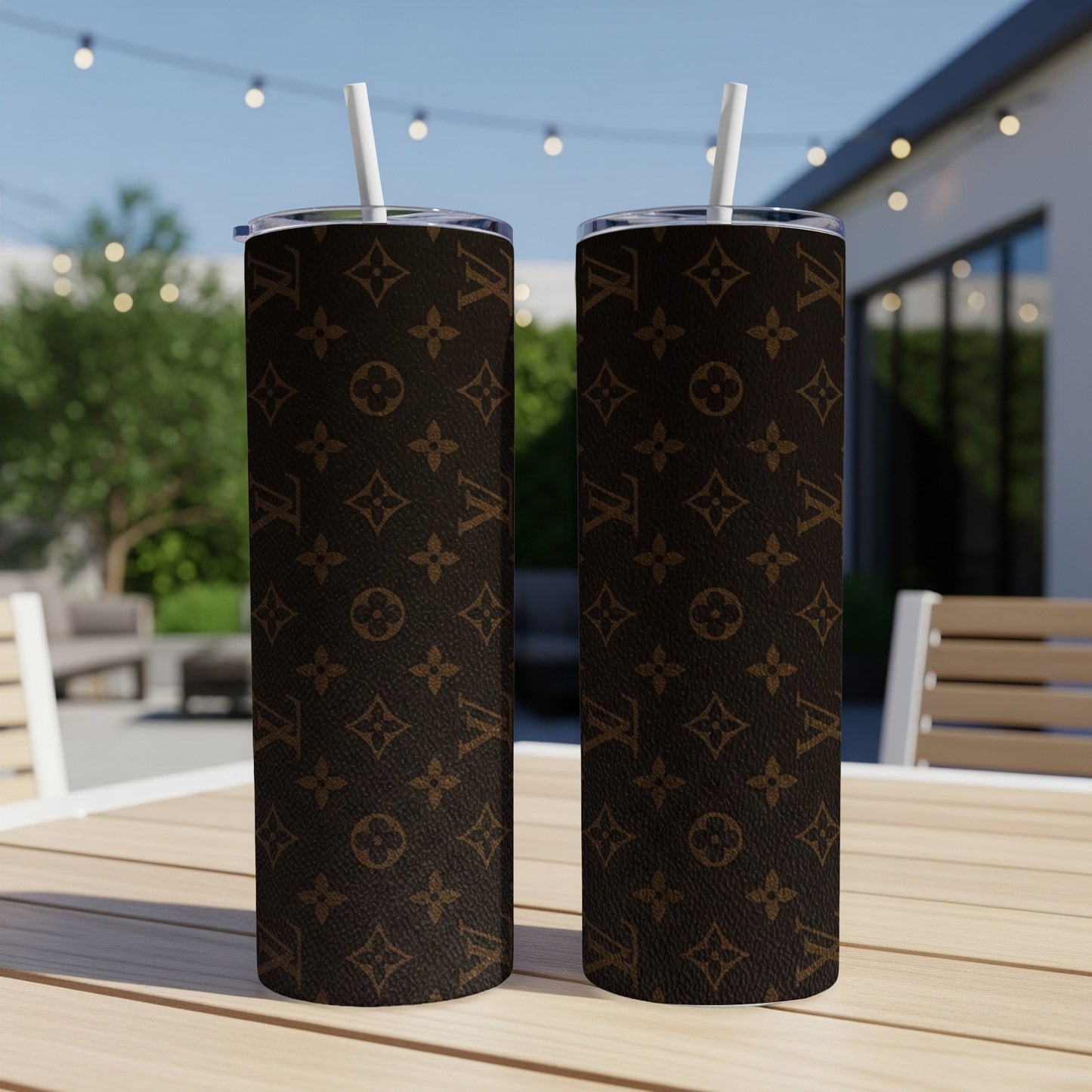 Two brown tumblers with LV monogram pattern on a table.