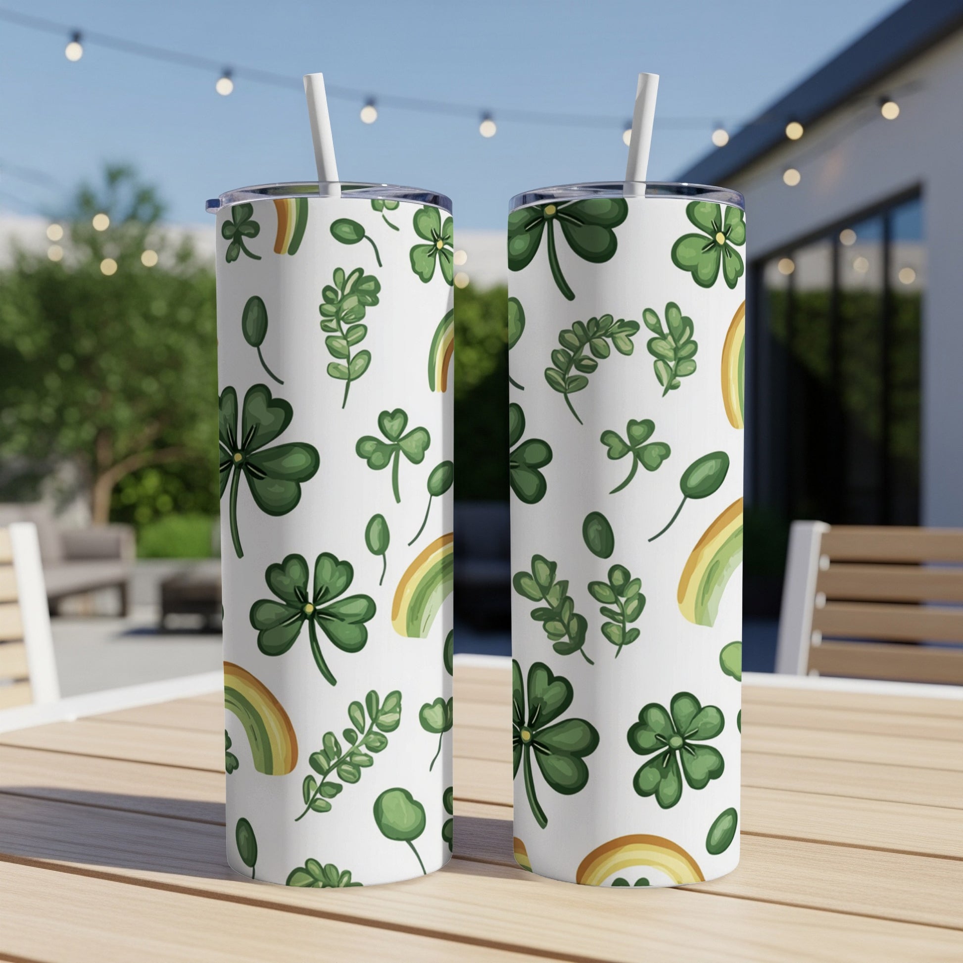 Two white tumblers with shamrocks and rainbows pattern.