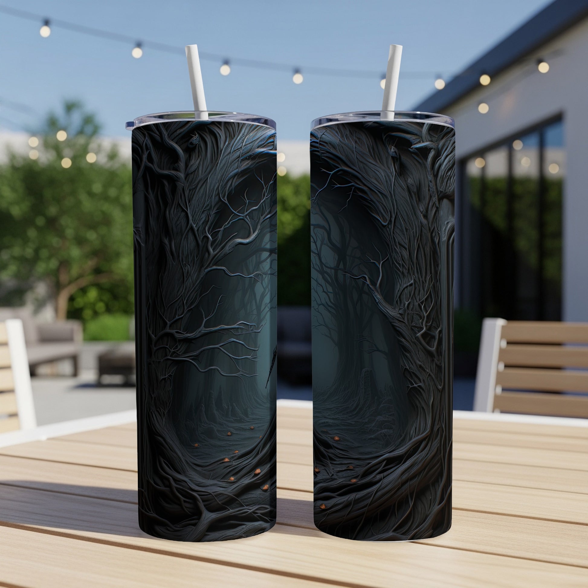 Two tumblers with a dark, gnarled forest design and white straws.