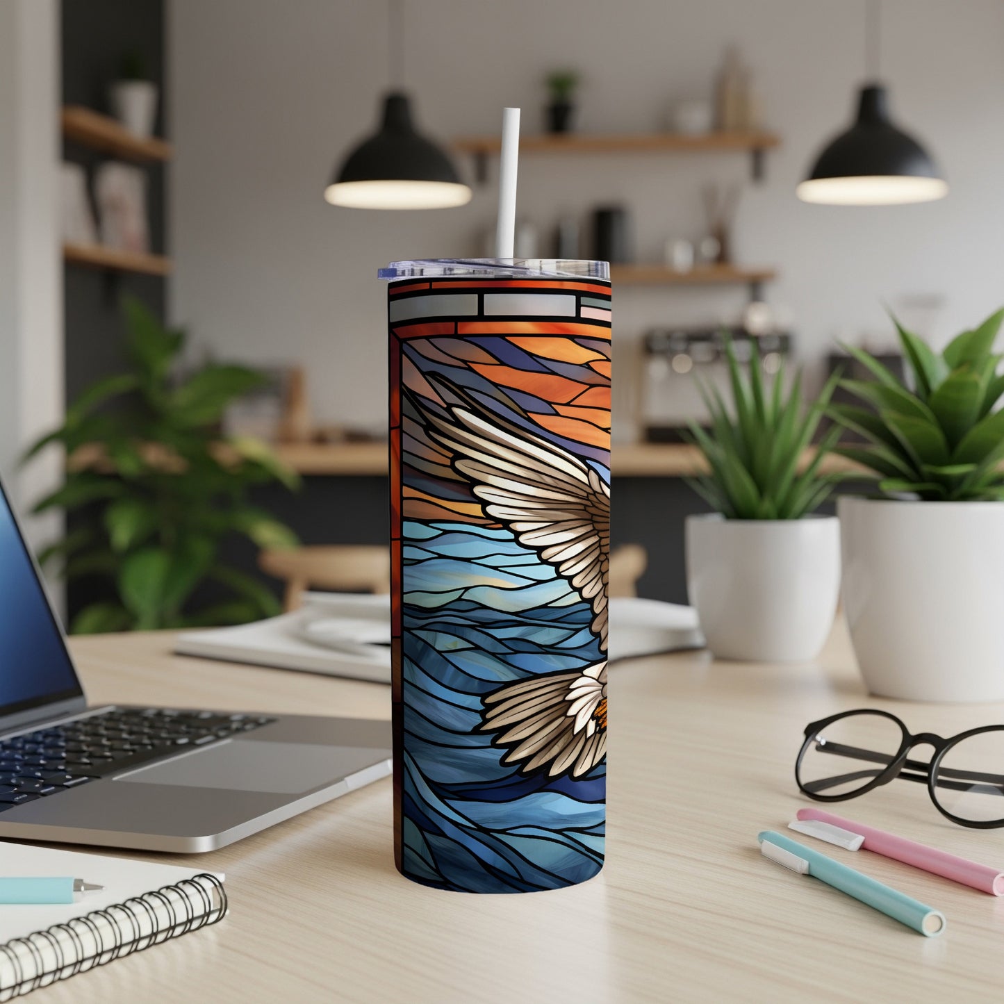 Stained glass tumbler with soaring eagle design on wavy water background.