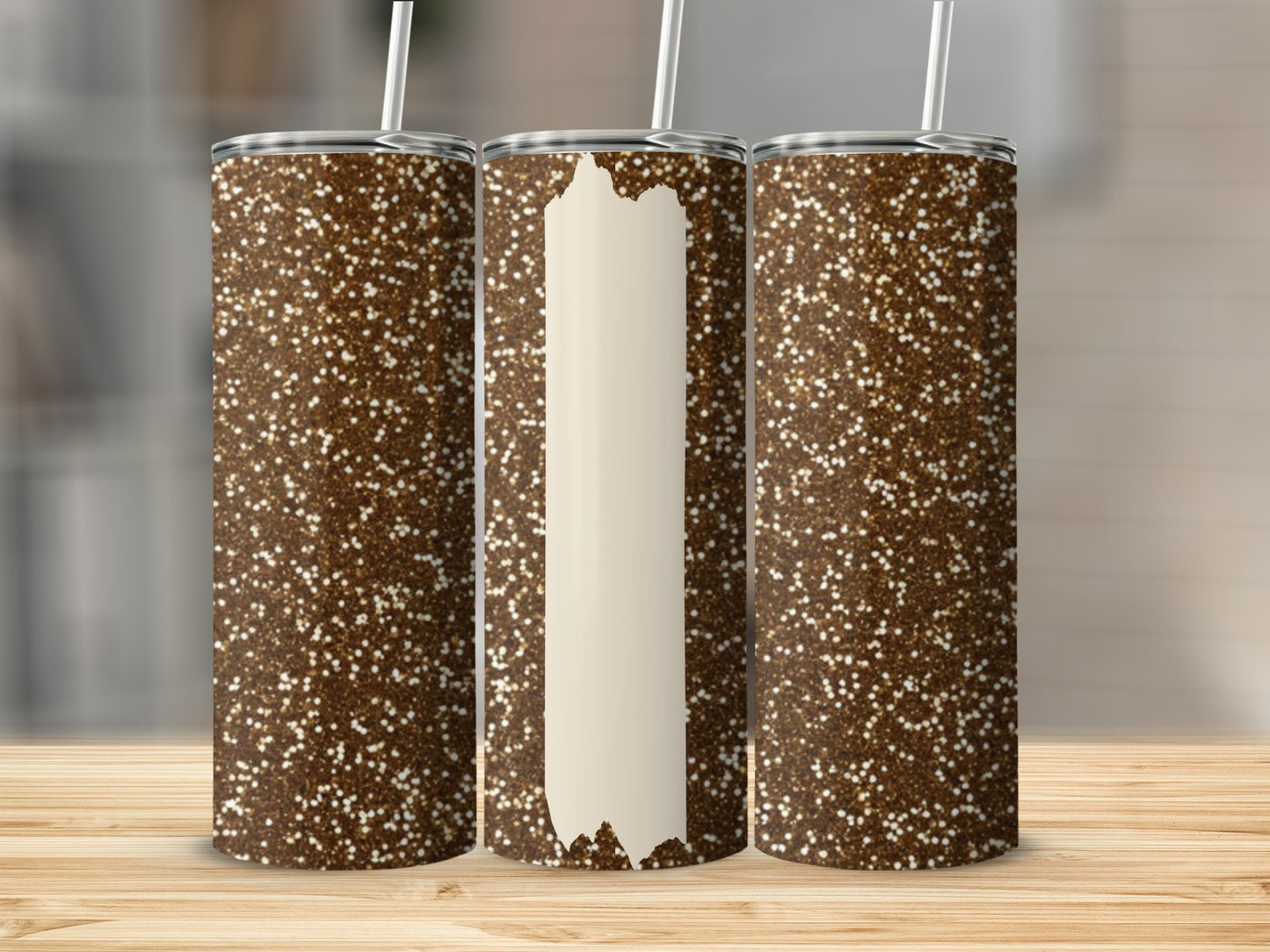 Three glittery brown tumblers with cream-colored vertical panels.
