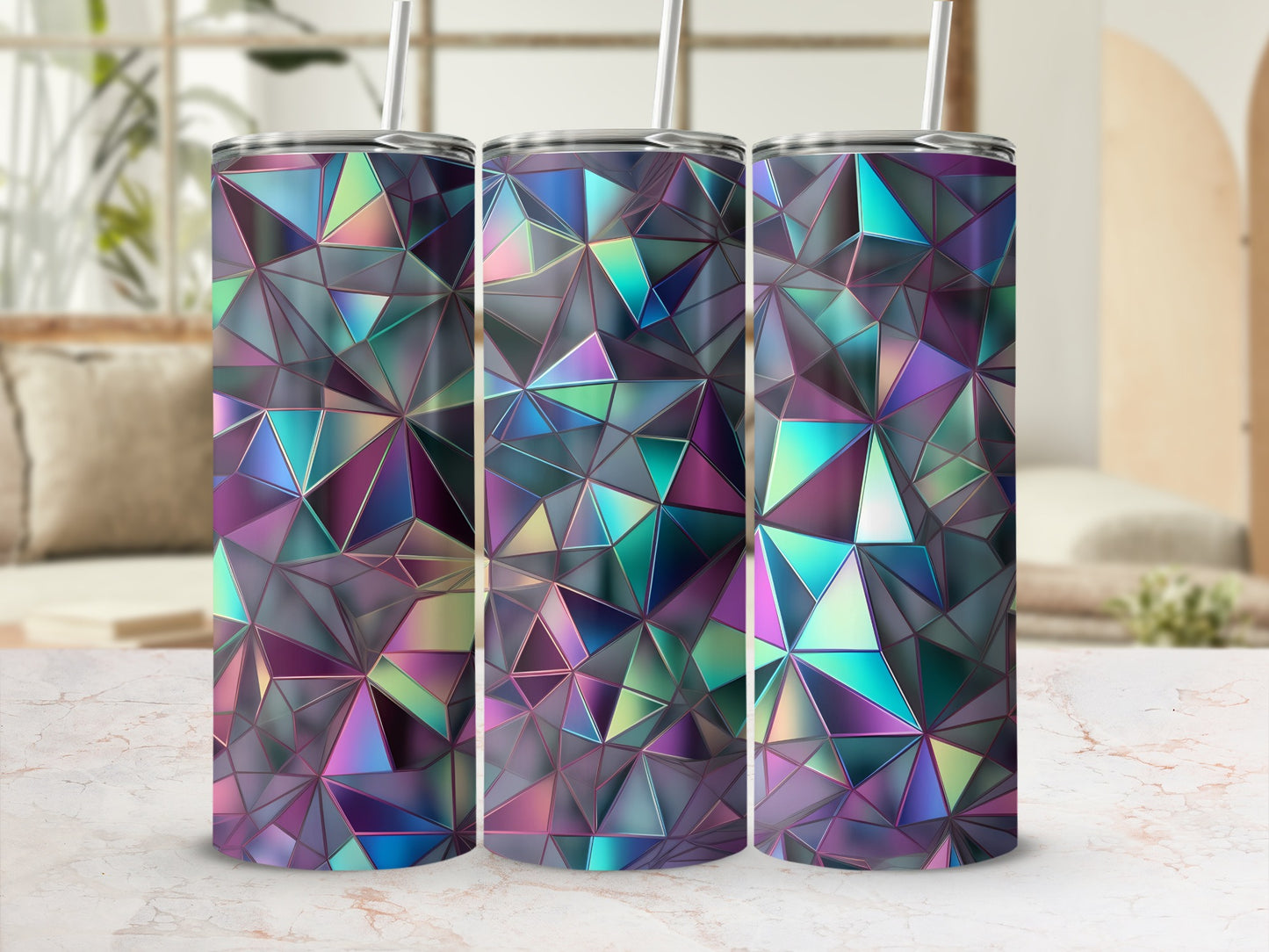 Three iridescent geometric tumblers with straws on a marble surface.