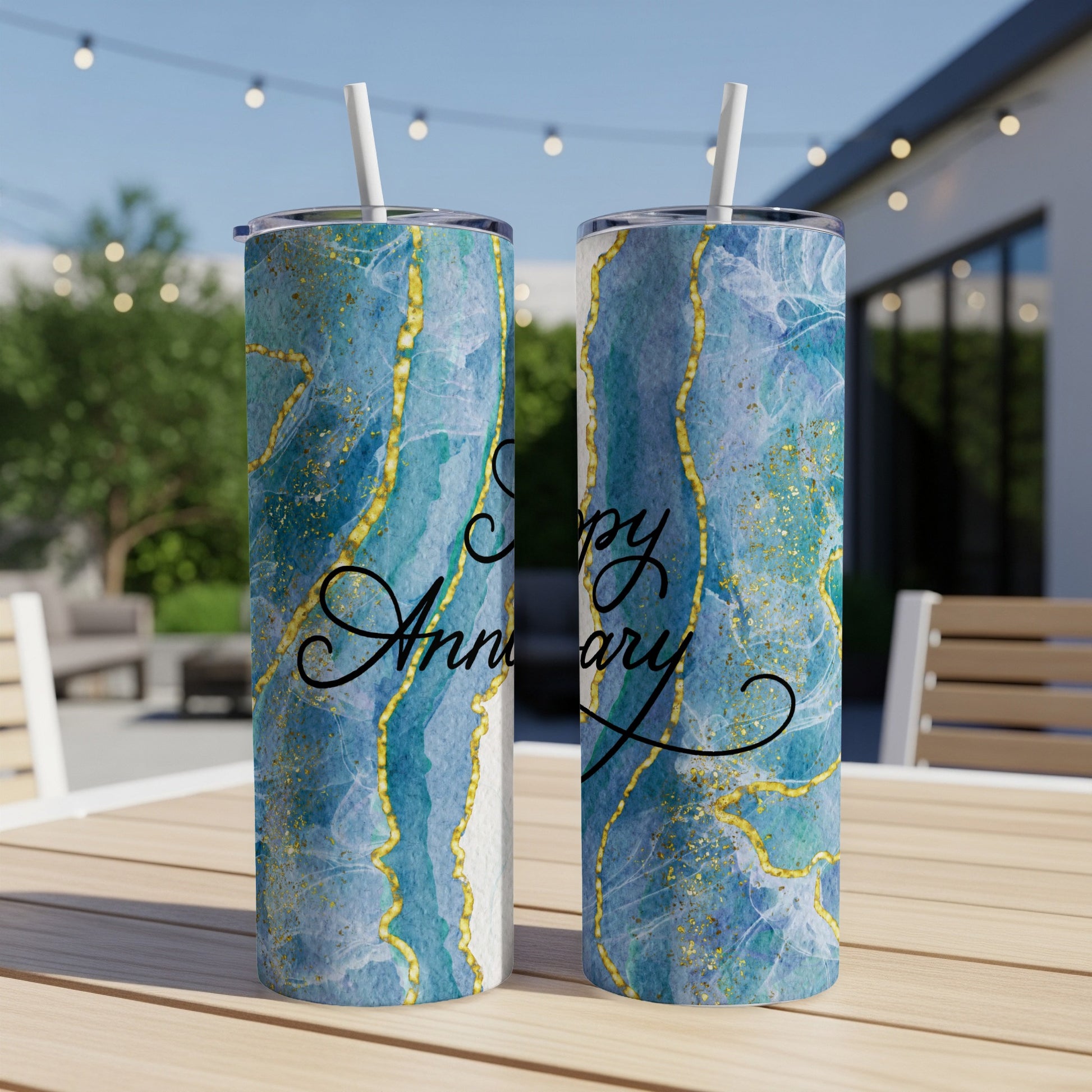 Two tumblers with blue marble and gold accents, saying "Happy Anniversary".