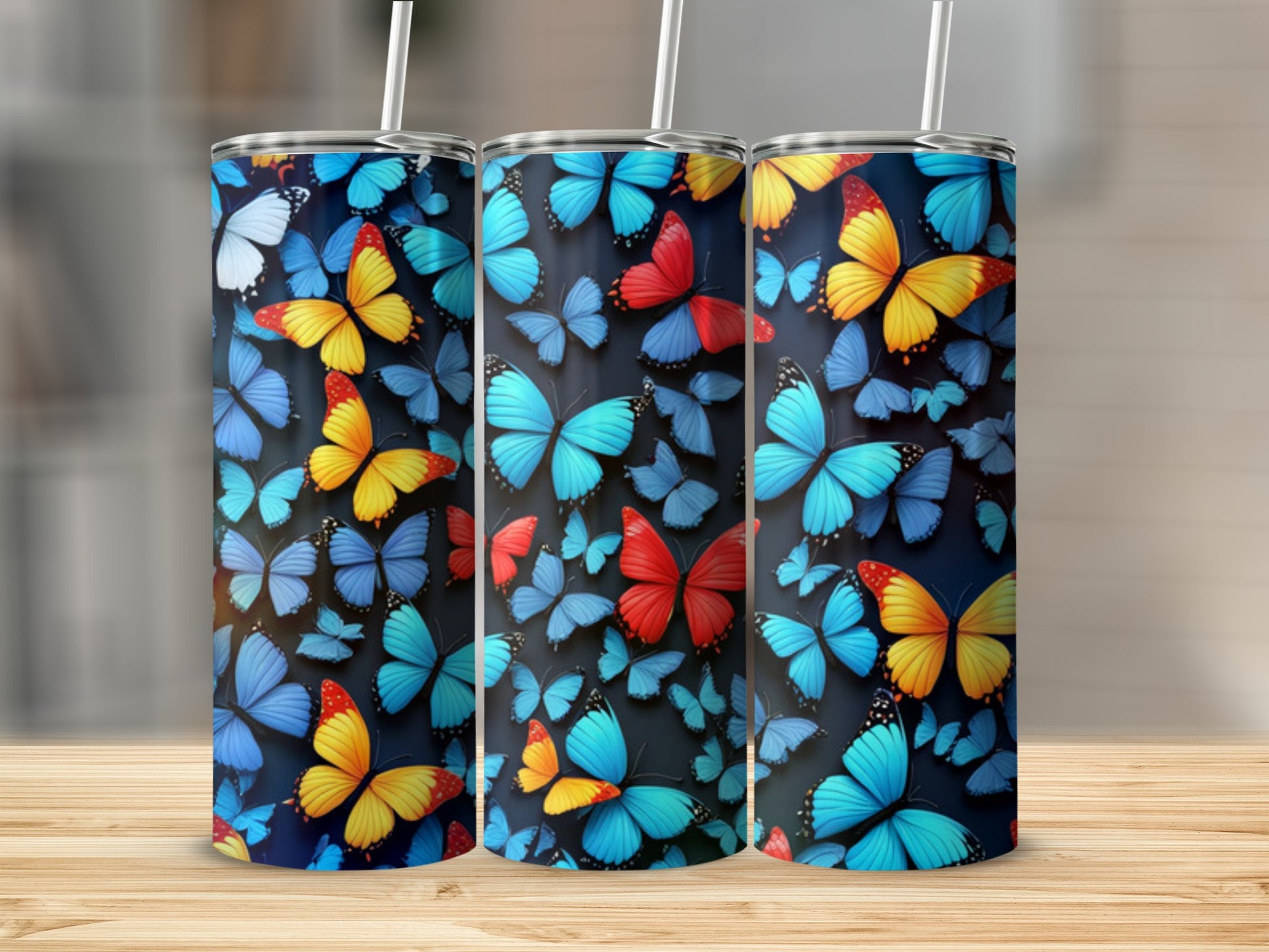 Three tumblers adorned with colorful butterfly patterns.