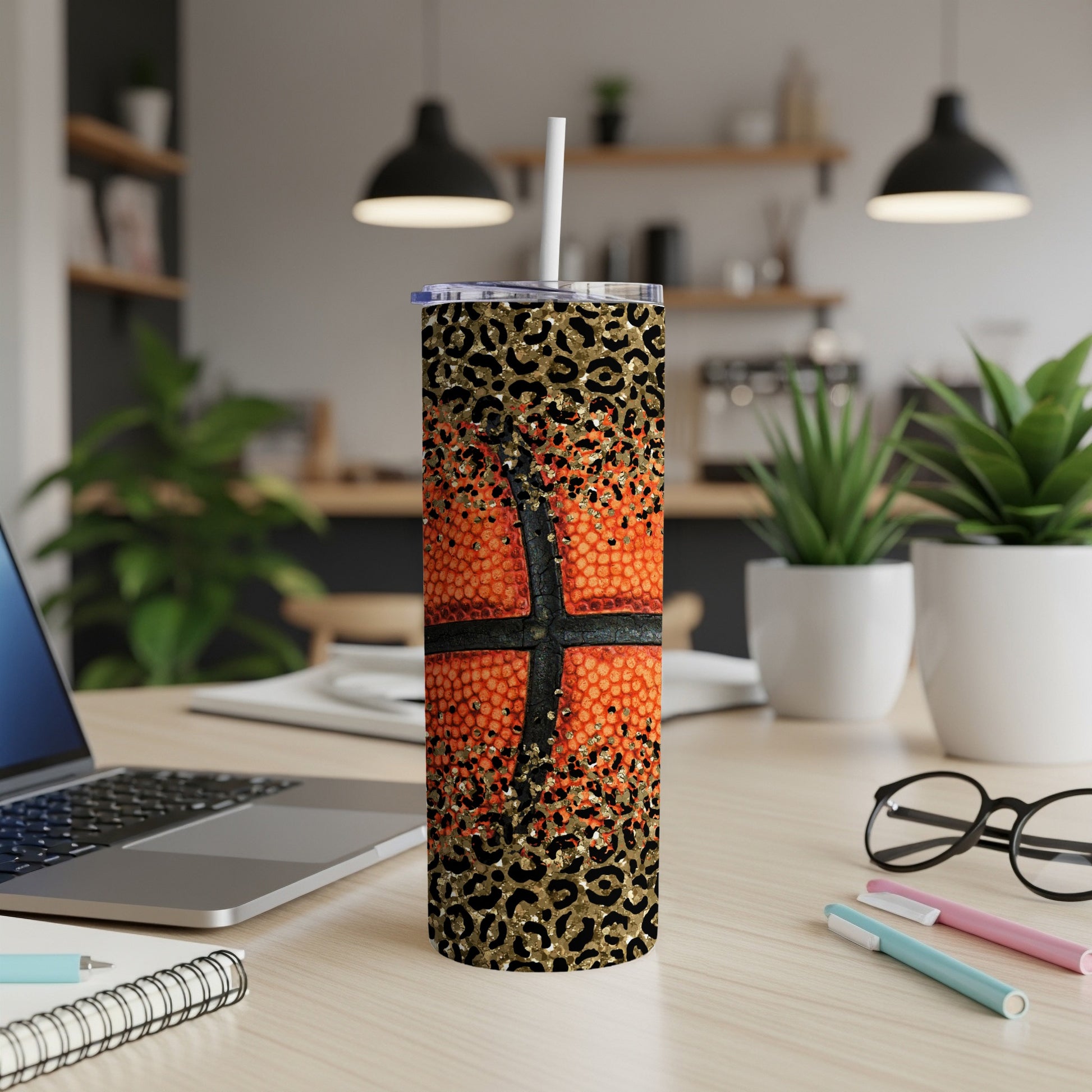 Basketball tumbler with leopard print and straw on a desk.