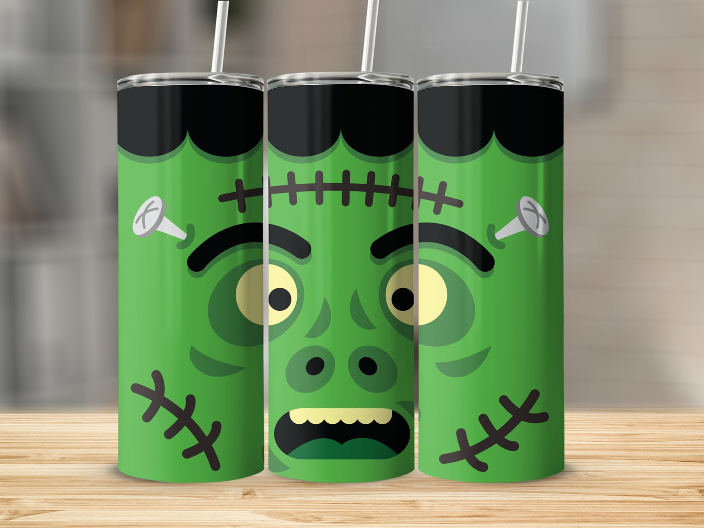 Three green tumblers with Frankenstein faces and straws.