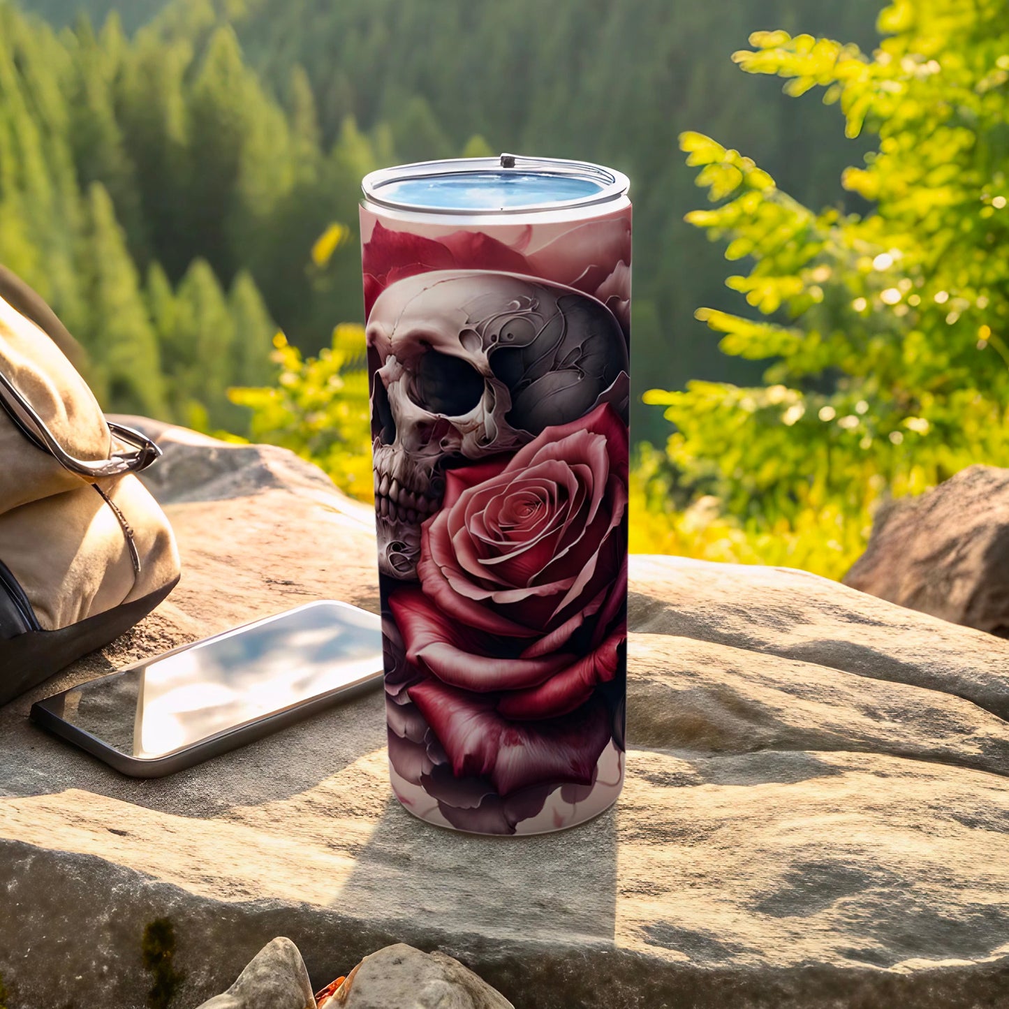 Skull and rose design on a stainless steel tumbler outdoors.