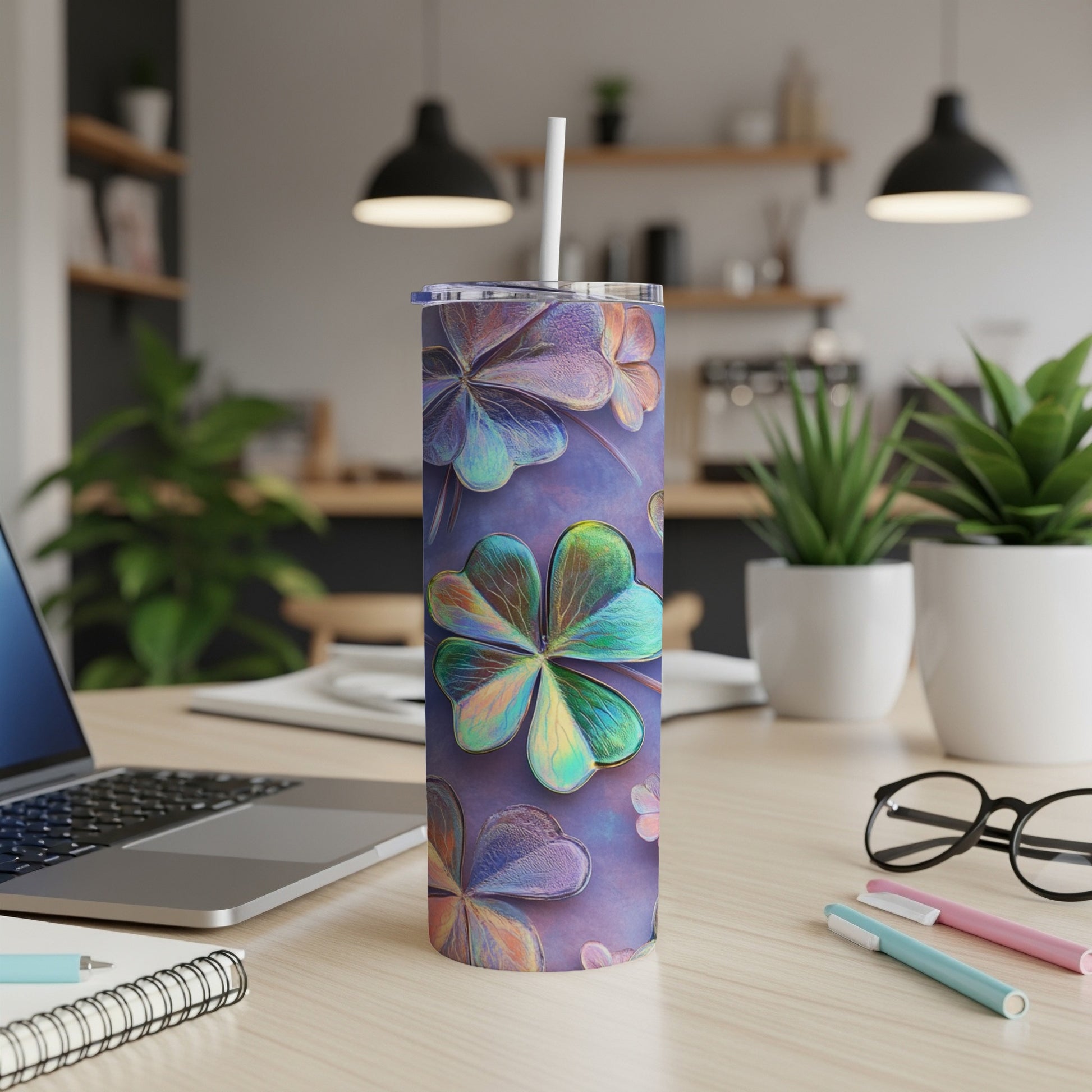 Purple tumbler with iridescent clover pattern on a desk.