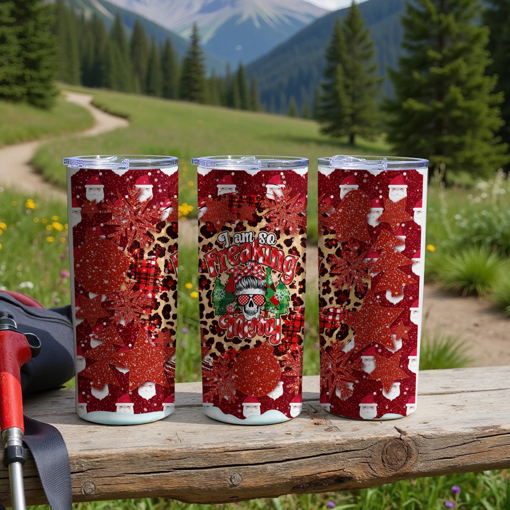 Three tall tumblers with a Christmas design and snowflakes.
