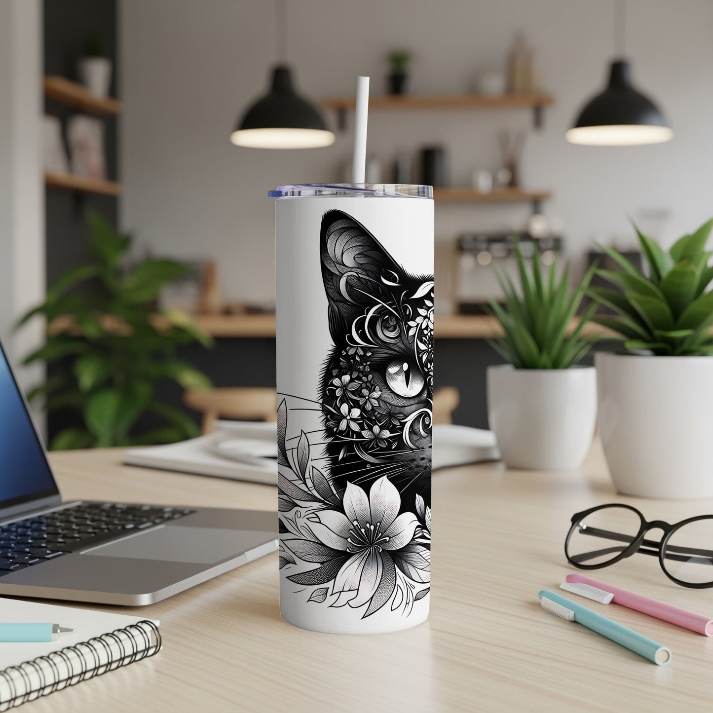 Black and white cat with floral design on a skinny tumbler.