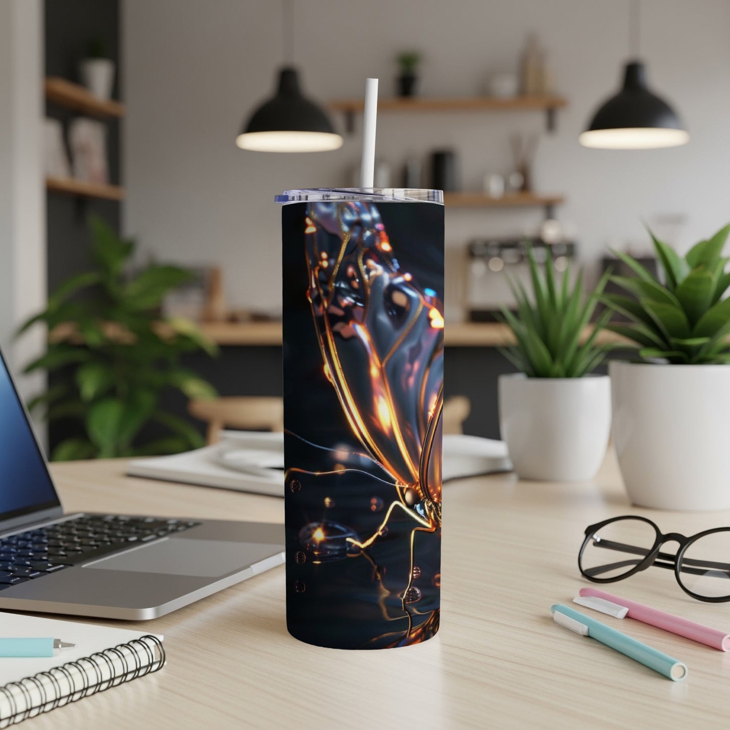 Tumbler with iridescent butterfly design on a wooden desk.