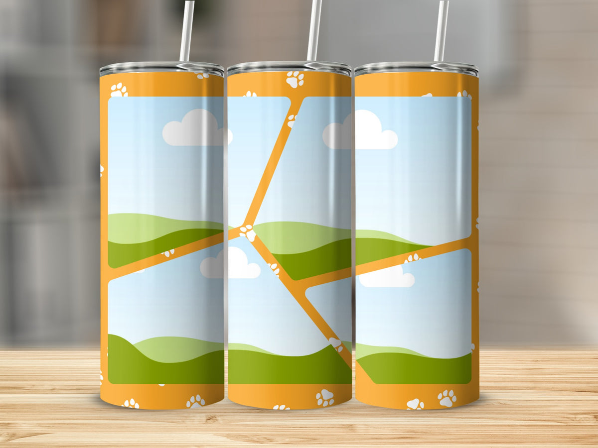 Three orange tumblers with paw print and landscape design.