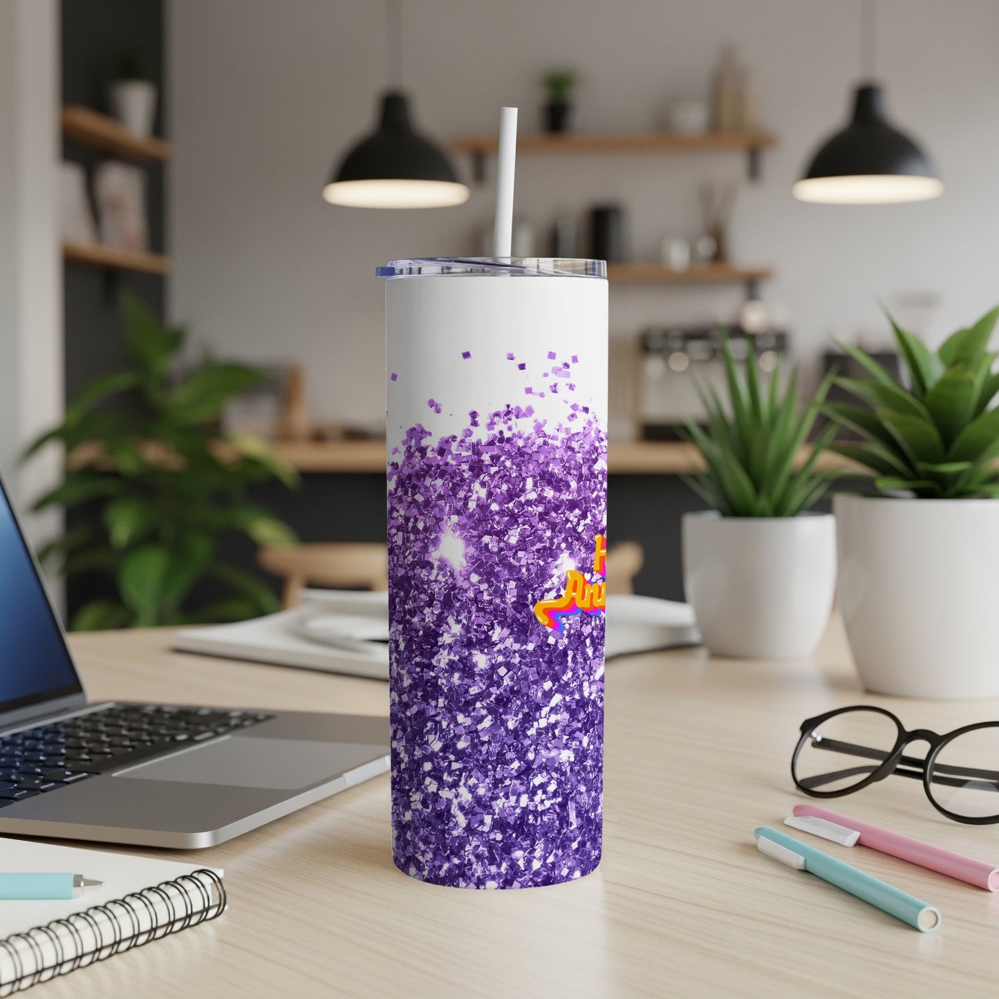 White tumbler with purple glitter and colorful text that reads "YOU ARE AMAZING".