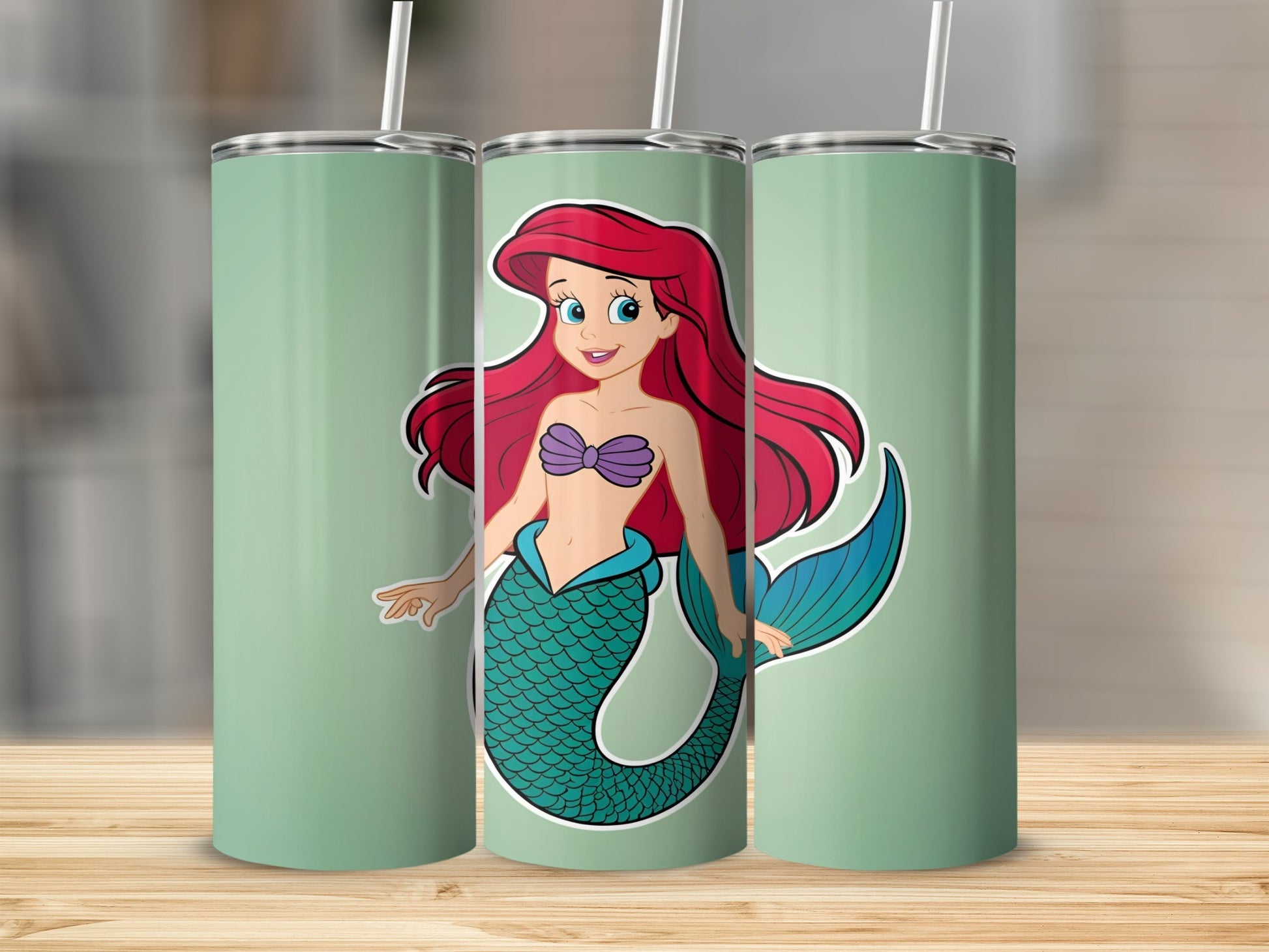 Ariel the mermaid on a mint green tumbler with a straw.