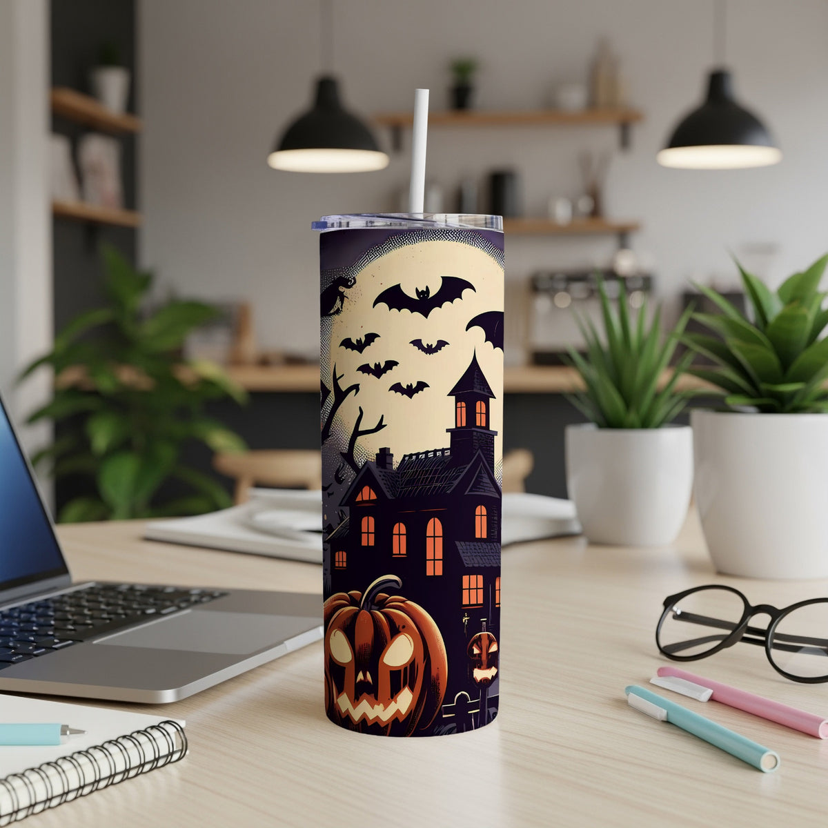 Tumbler with a Halloween scene featuring a haunted house, bats, and a jack-o'-lantern.