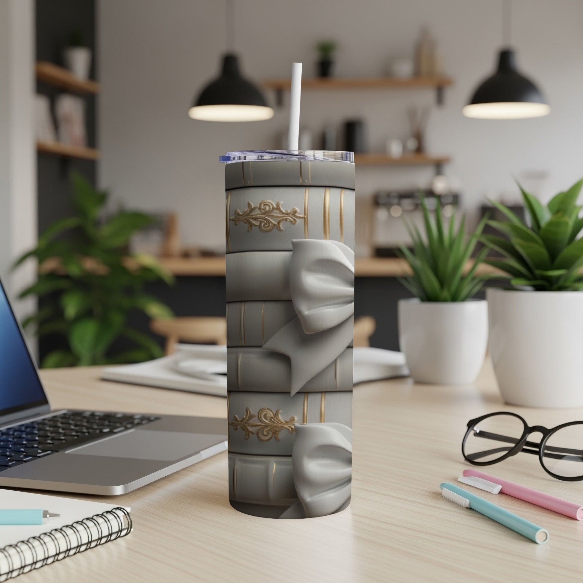 Gray tumbler with stacked books and gold bow design.