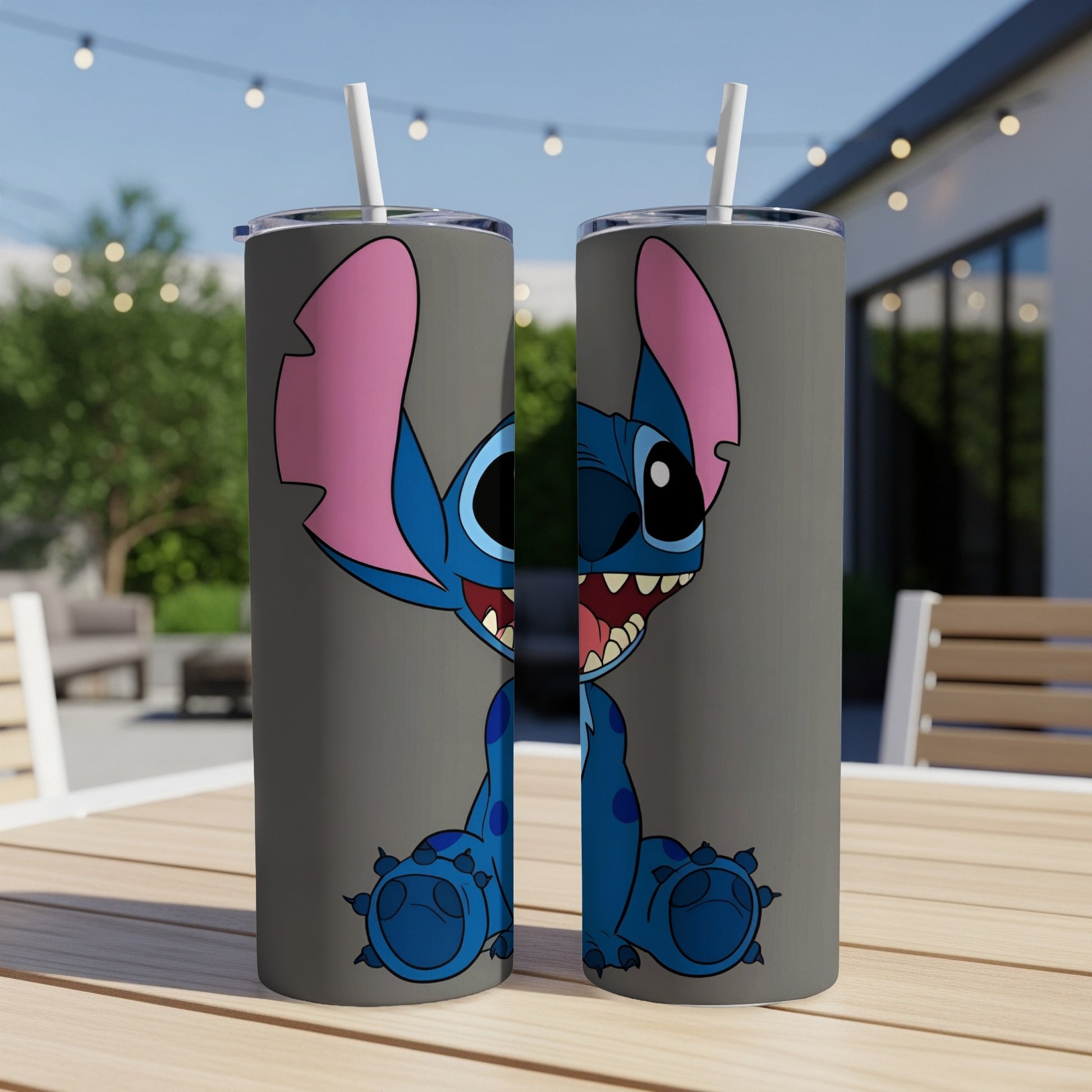 Two tumblers featuring a cartoon Stitch character with wide eyes and a grin.