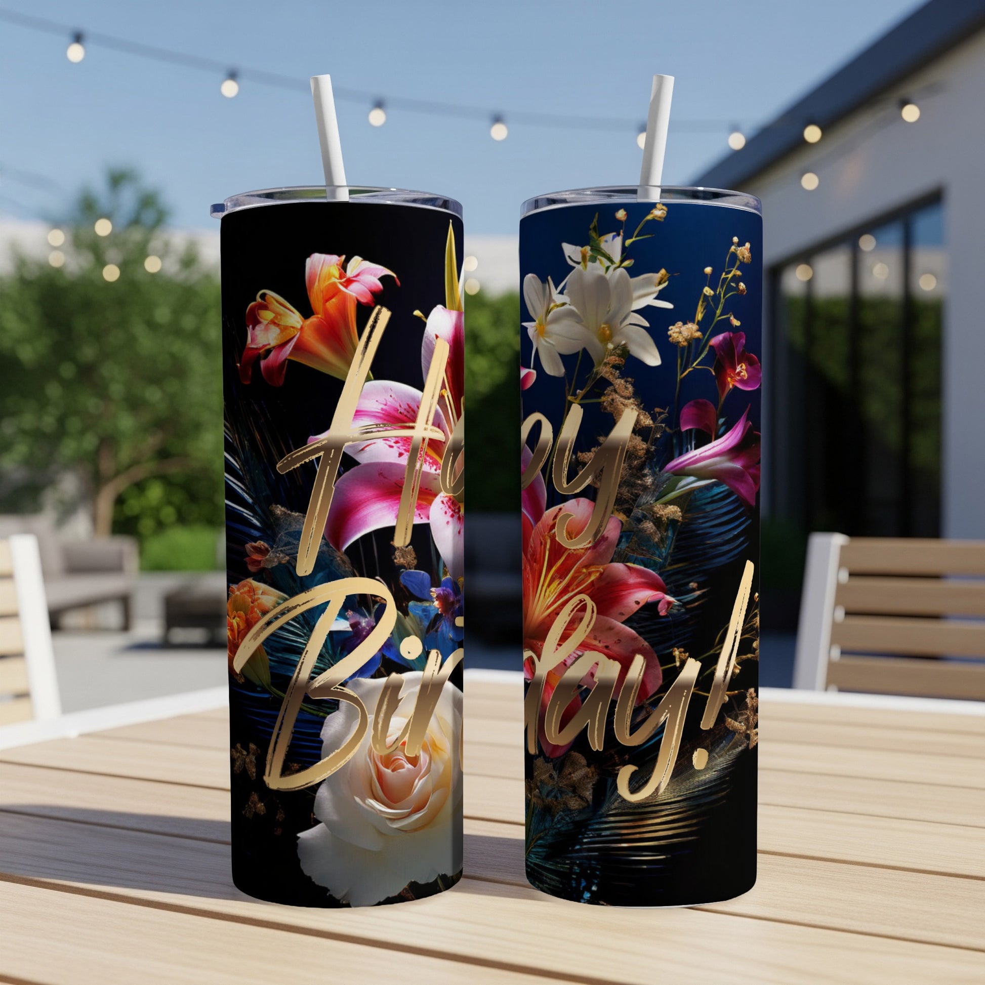 Two floral tumblers with "Happy Birthday!" text on a table.