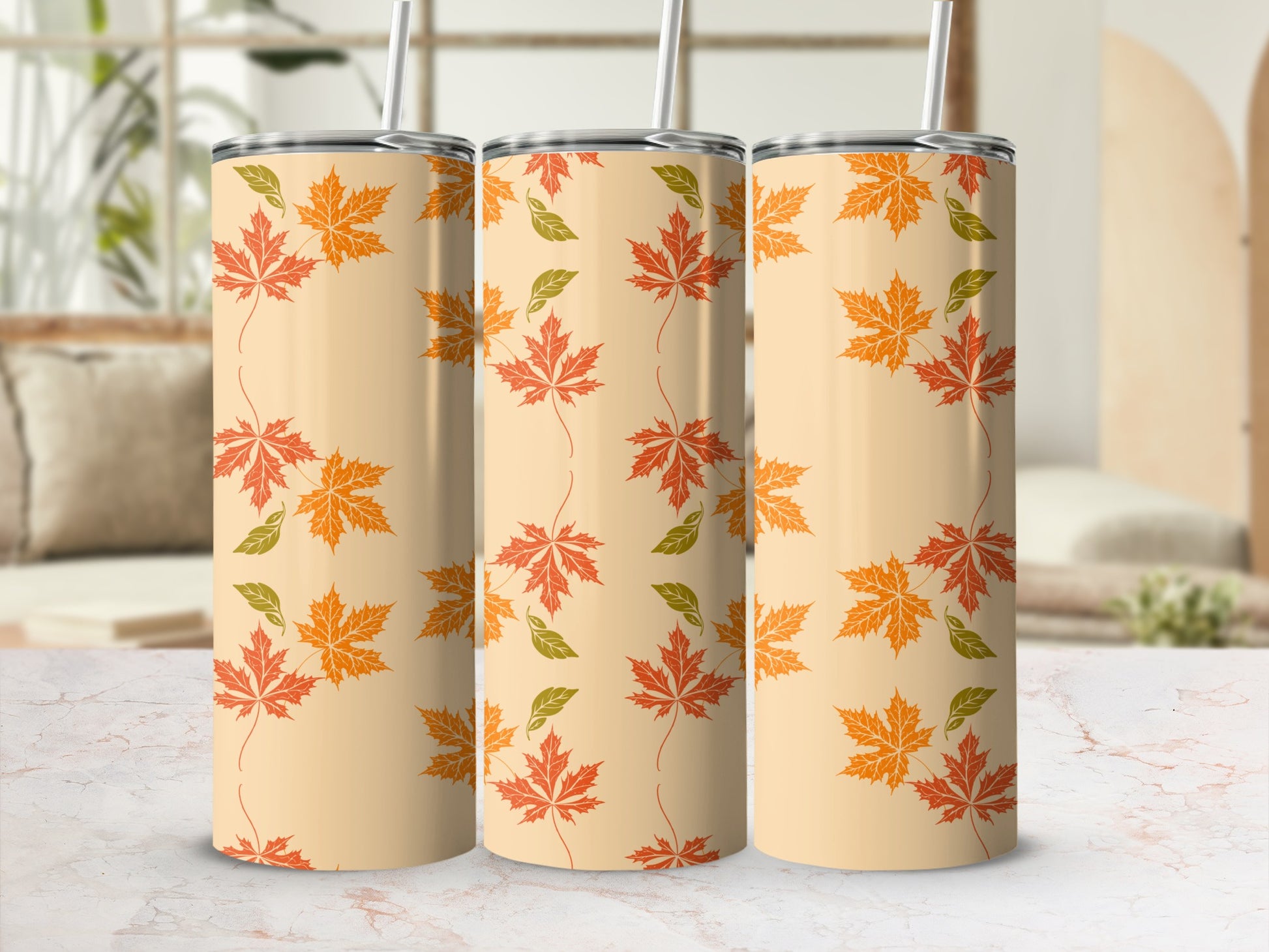 Beige tumbler with repeating pattern of orange and green maple leaves.
