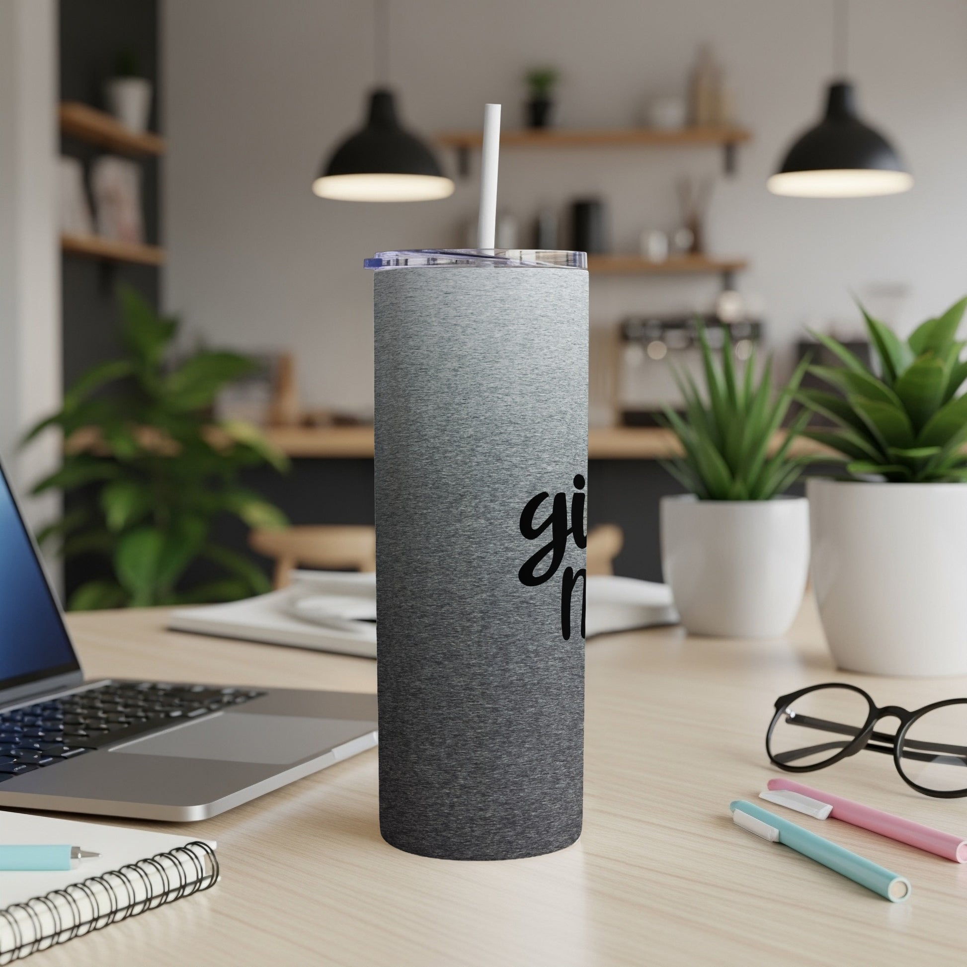 Gradient grey tumbler with "girl boss" text and straw on a desk.