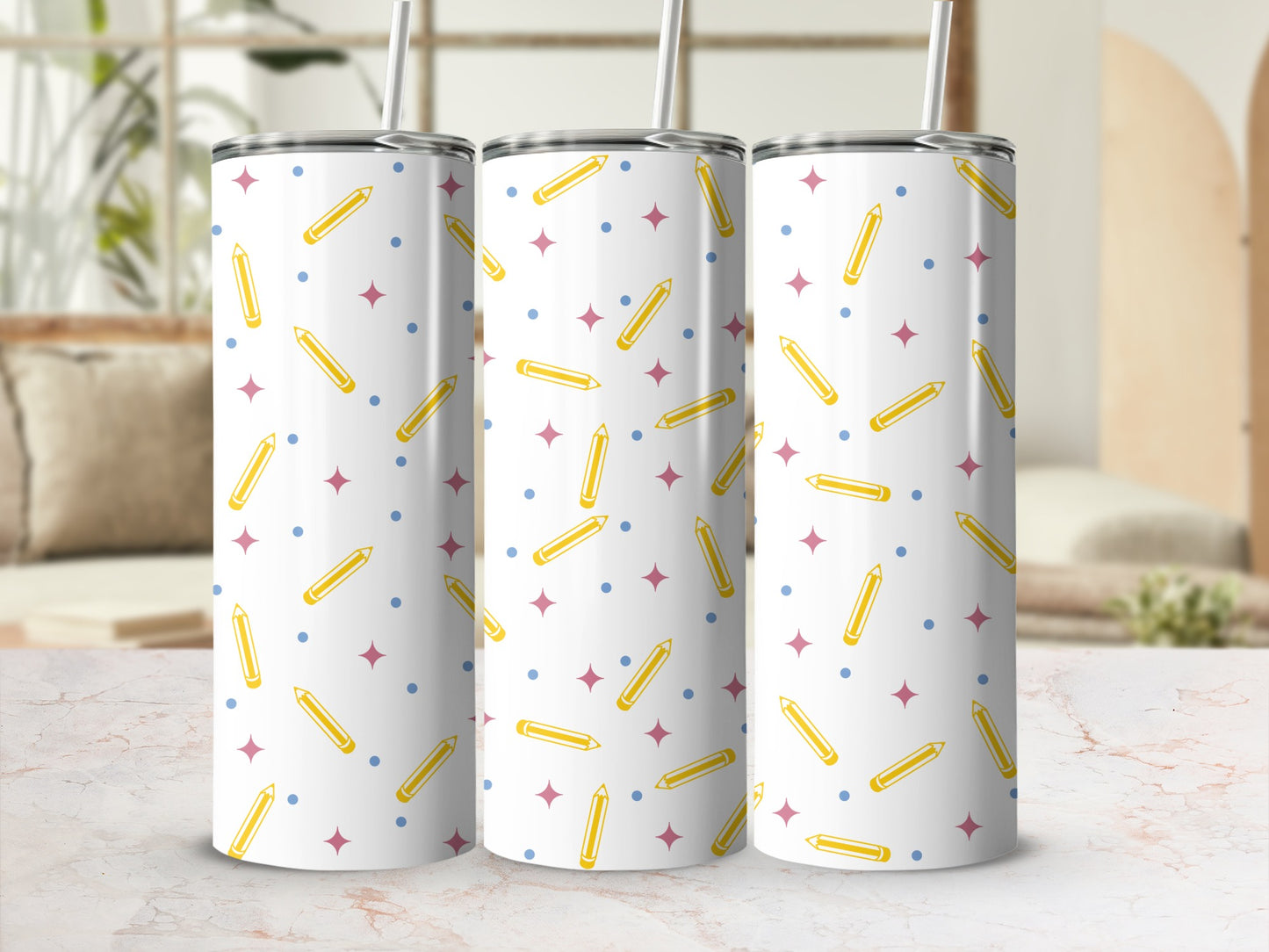 Three tumblers with pencil and star pattern, on a marble surface.