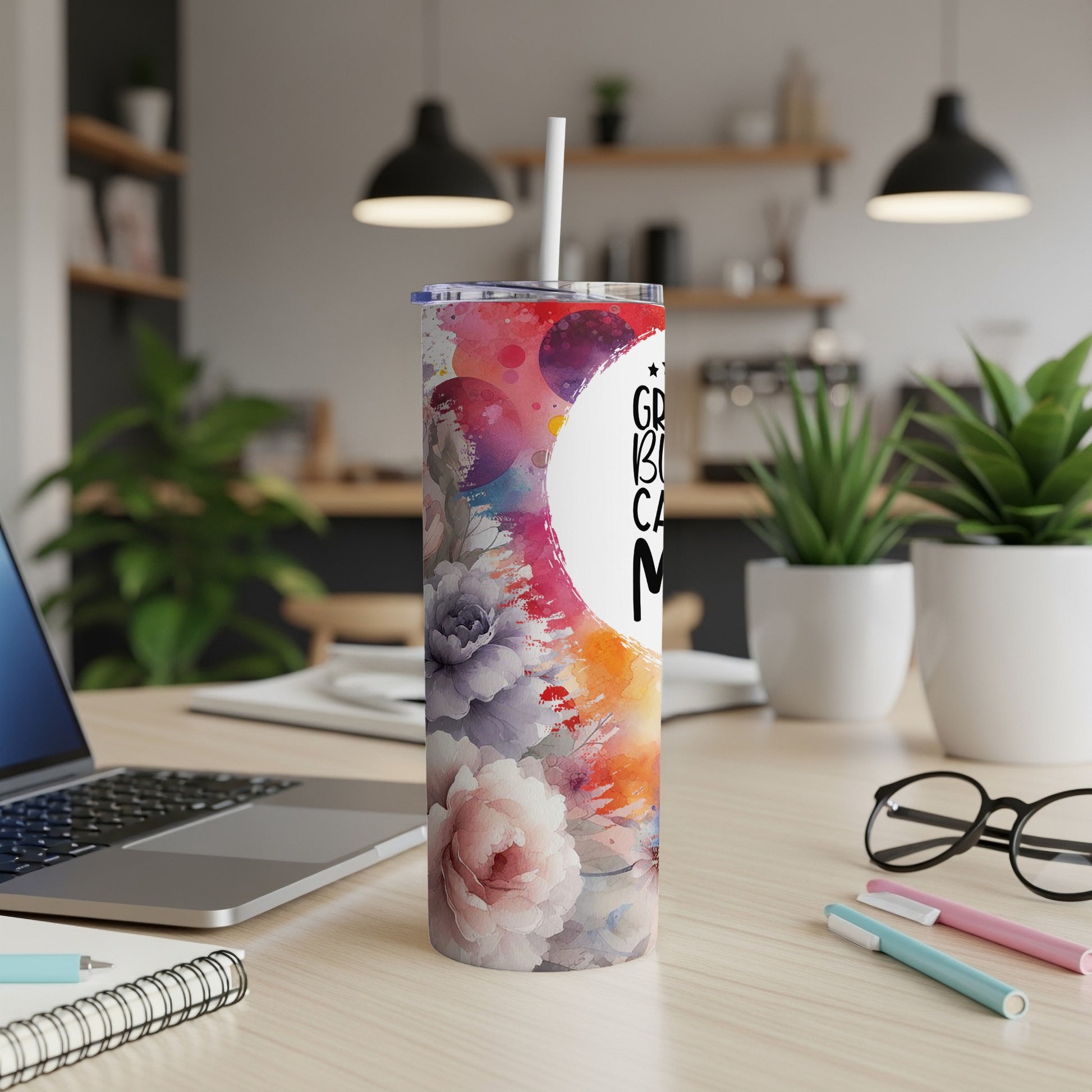 Floral tumbler with "Grandma's Been Caring" text.