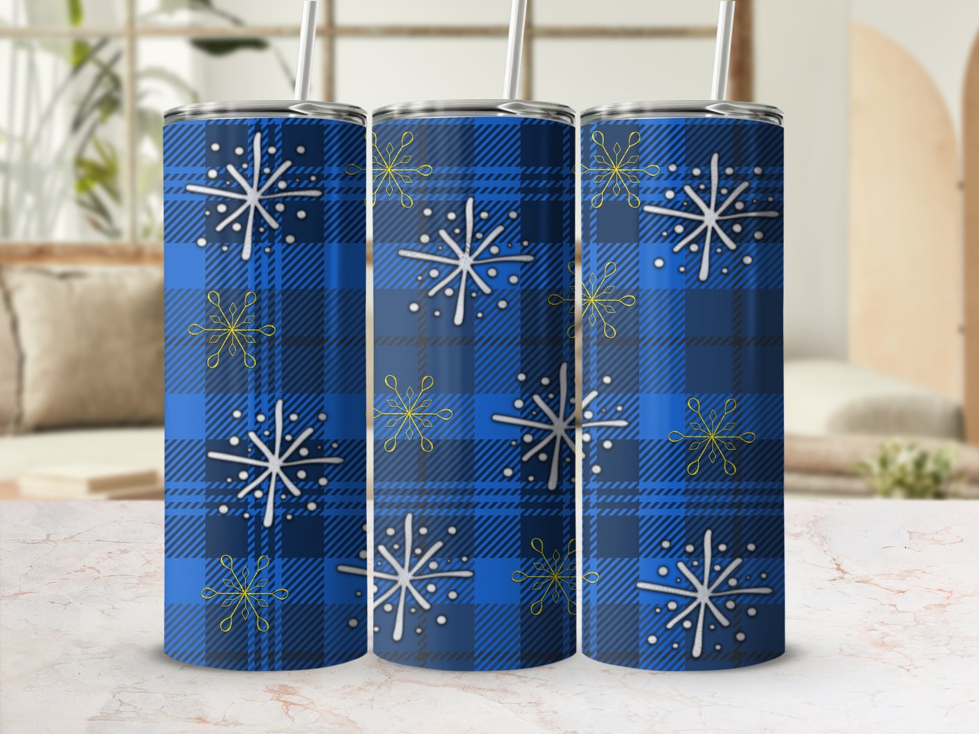 Blue plaid tumbler with white snowflakes and yellow accents.