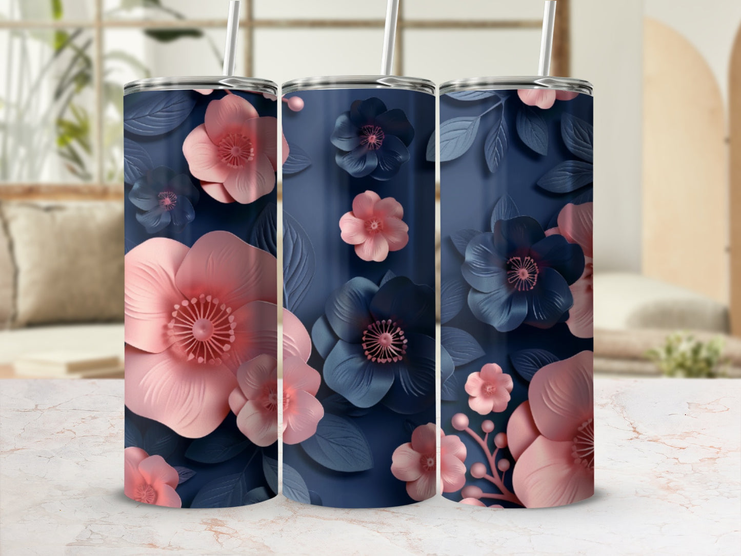 Three navy blue tumblers with pink and blue floral designs.