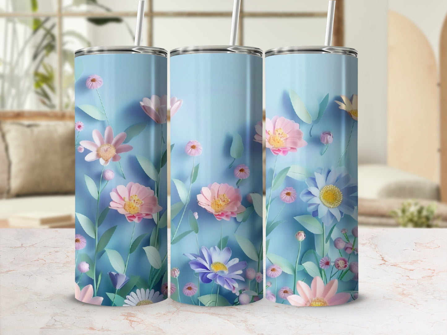 Three tall tumblers with a pastel floral and leaf design on a marbled surface.