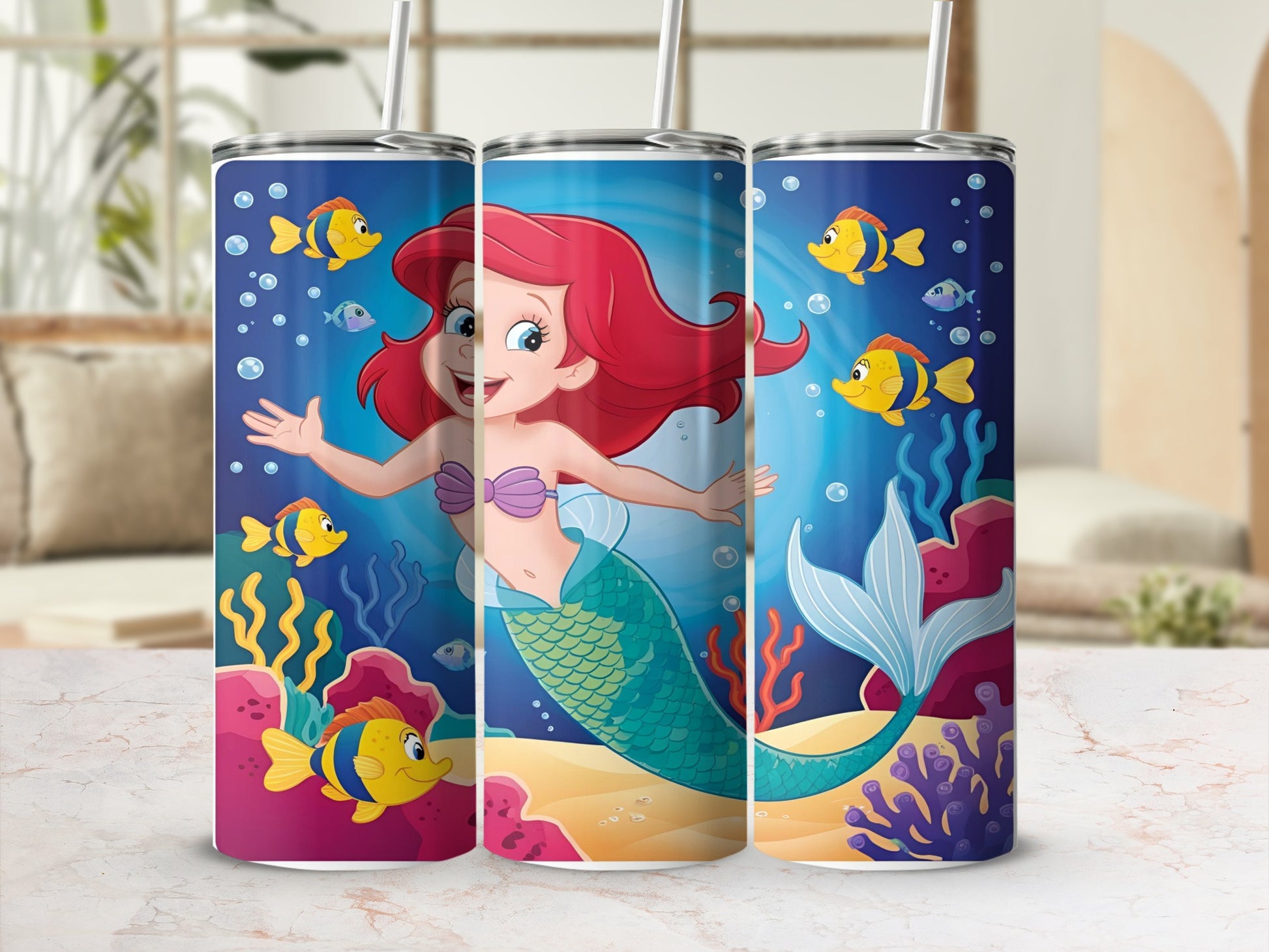 Ariel the mermaid with colorful fish and coral on a blue background.