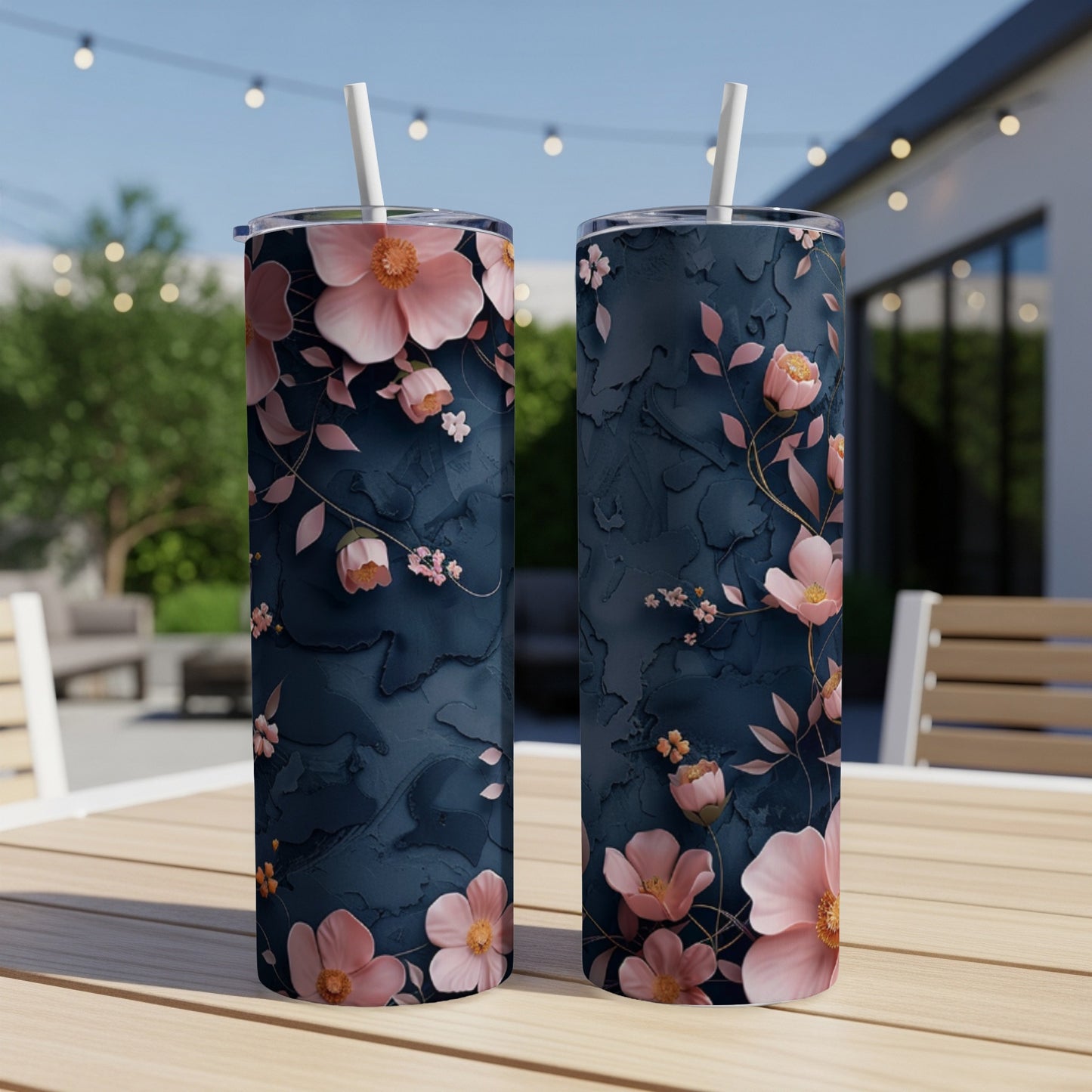 Two navy blue tumblers with pink floral and vine pattern.