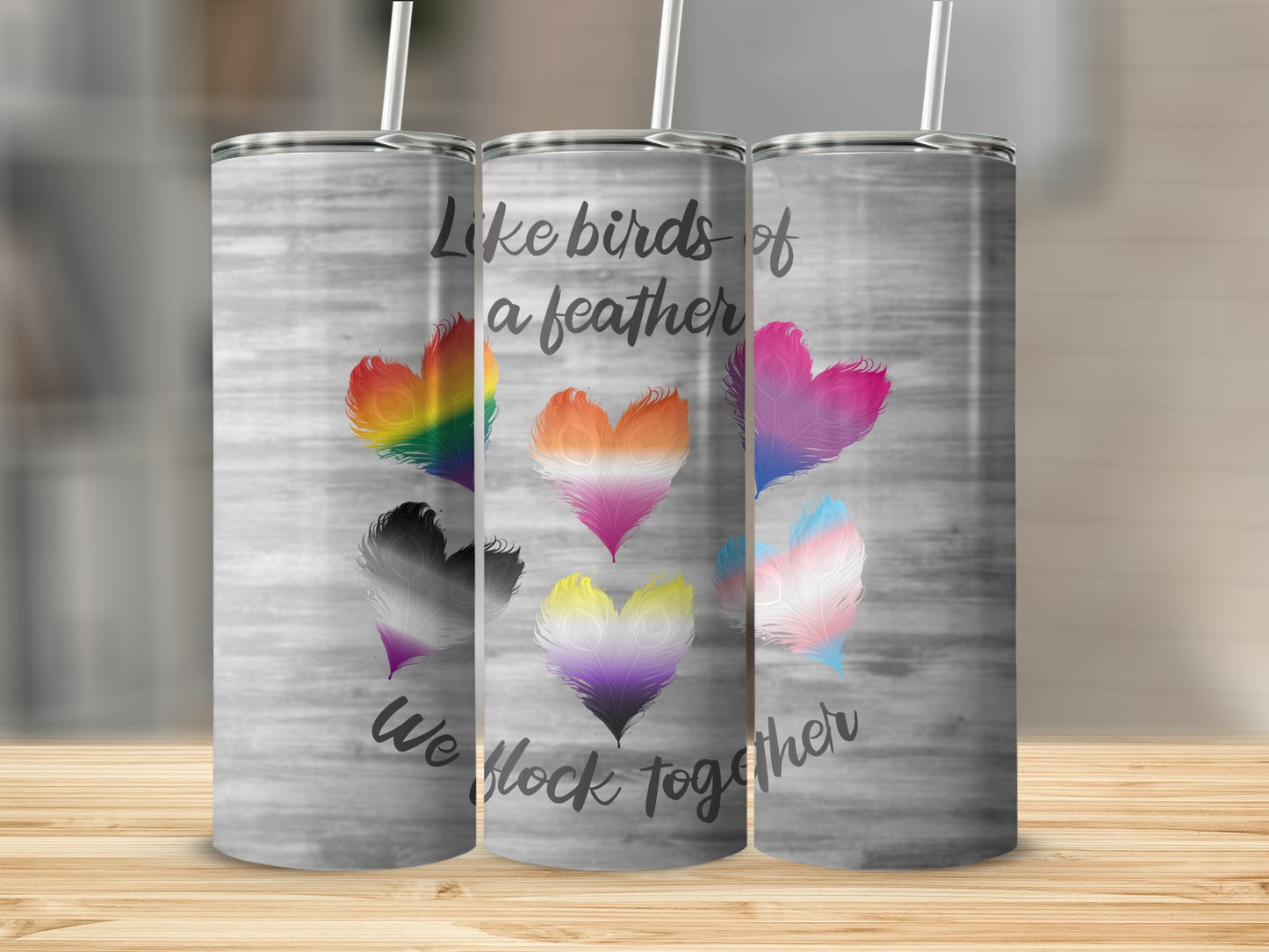Tumbler with rainbow feathers forming hearts and text "Like birds of a feather we flock together."